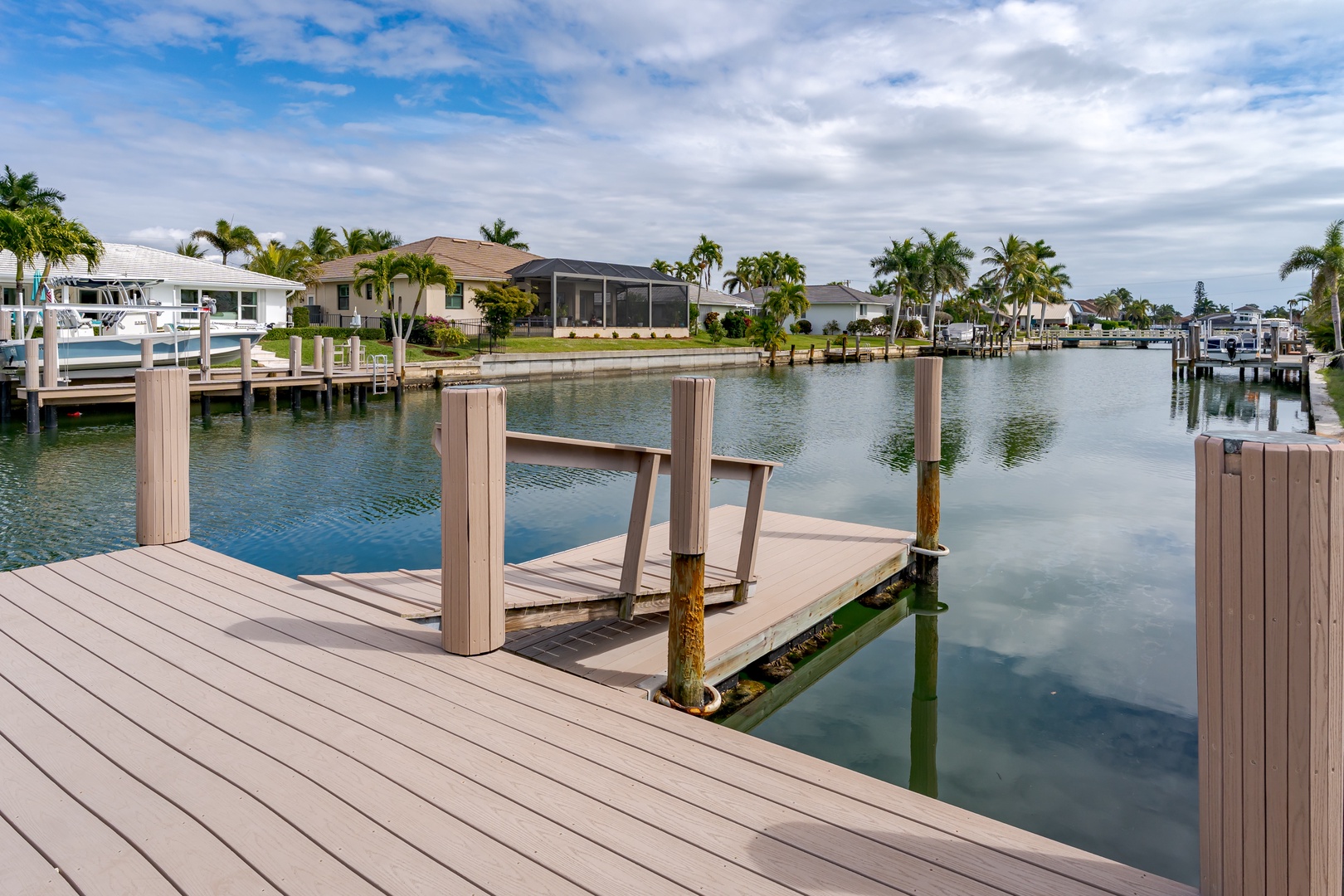 Waterfront community with private docks and palm-lined canals under bright Florida skies.