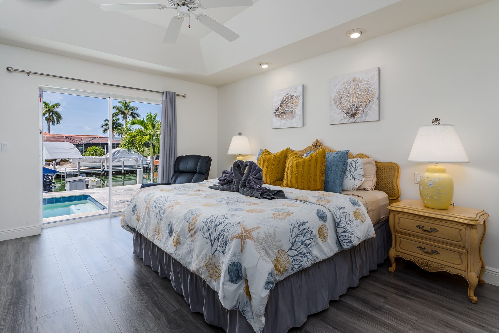 Wake up to tropical views and poolside tranquility in this serene bedroom, where coastal charm and comfort blend perfectly for your relaxing escape.