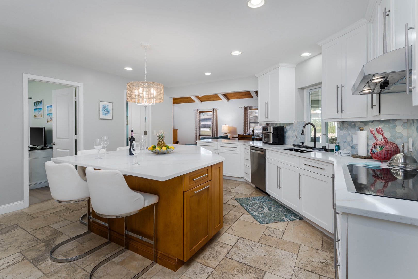 Your gourmet kitchen awaits with sleek white counters, modern appliances, and a stunning island perfect for morning coffee or evening wine.