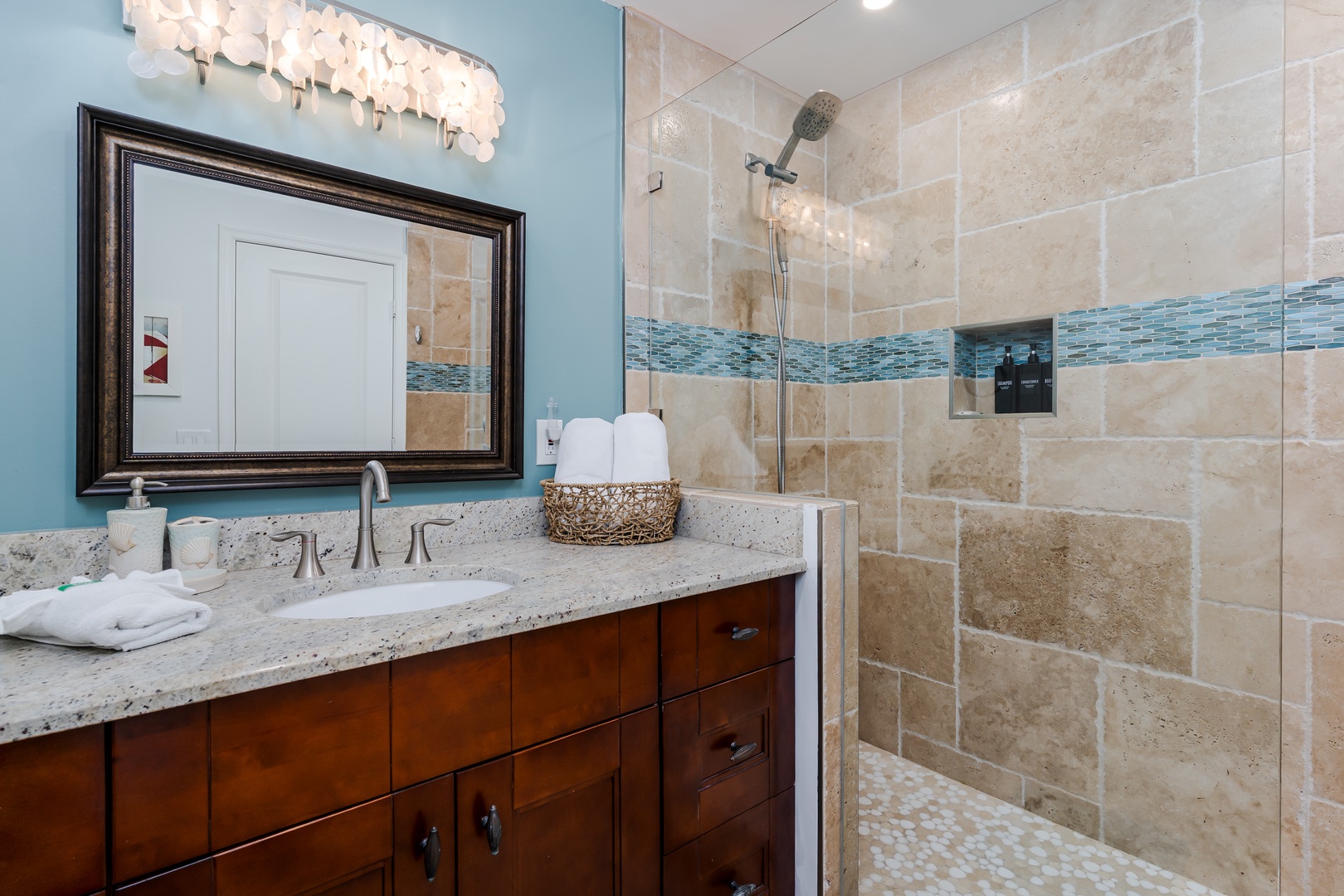 Indulge in your spa-like ensuite with elegant travertine tiles, a rainfall shower, and coastal-inspired accents that create your perfect retreat.