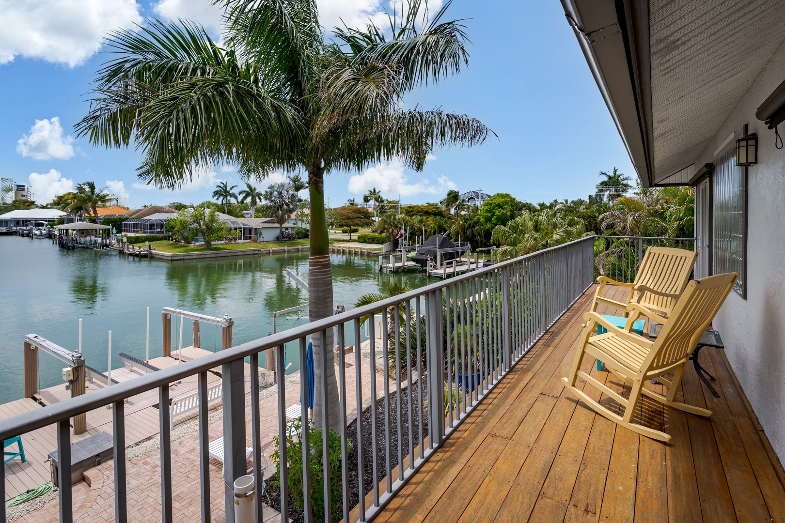Peaceful waterfront neighborhood with palm-lined canal views, private dock access, and charming low-rise homes across the water—perfect for boat lovers and those seeking a tranquil tropical setting.