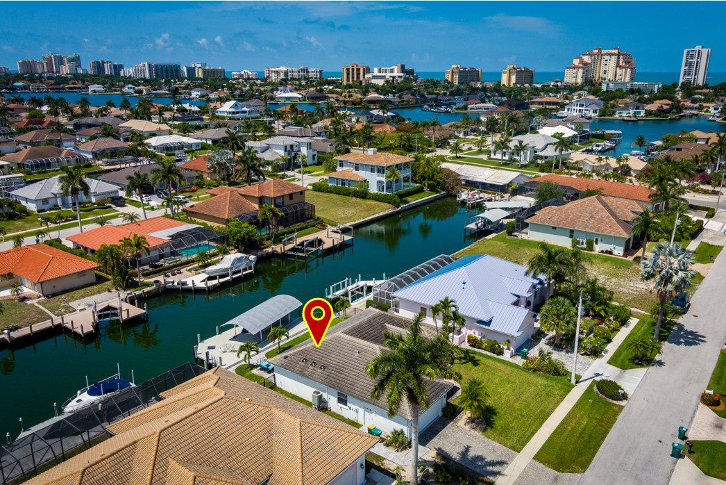 Waterfront property located in a peaceful canal neighborhood, surrounded by palm-lined streets and within easy reach of coastal beaches and downtown high-rises.