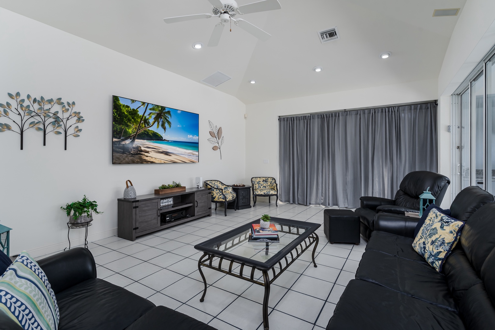 Sink into plush leather seating in your spacious living room with vaulted ceilings, a large flatscreen TV, and cool tile floors beneath your feet—perfect for unwinding after your adventures.