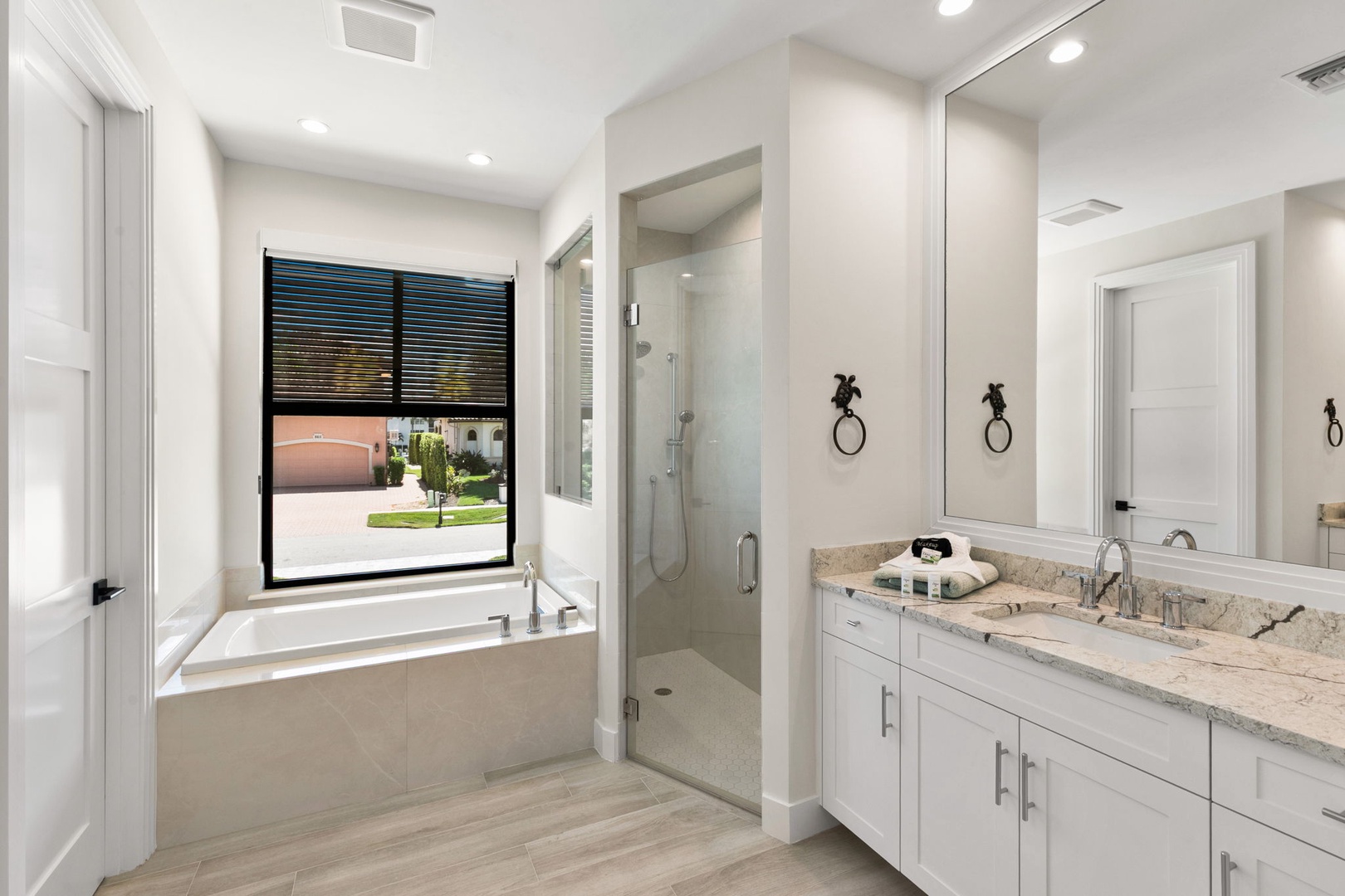 Step into your private spa-like retreat with a soaking tub, walk-in shower, and bright modern finishes. Natural light and clean lines create a calming space where you can truly unwind.