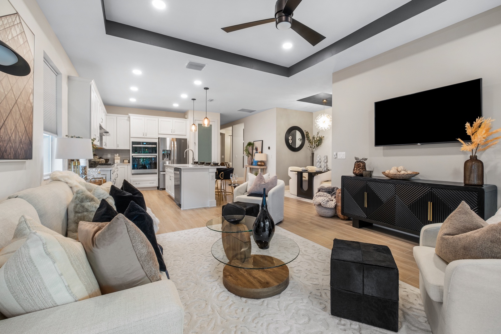 Relax in your stylish open-concept space with plush seating, modern kitchen, and entertainment center perfect for unwinding after exploring.