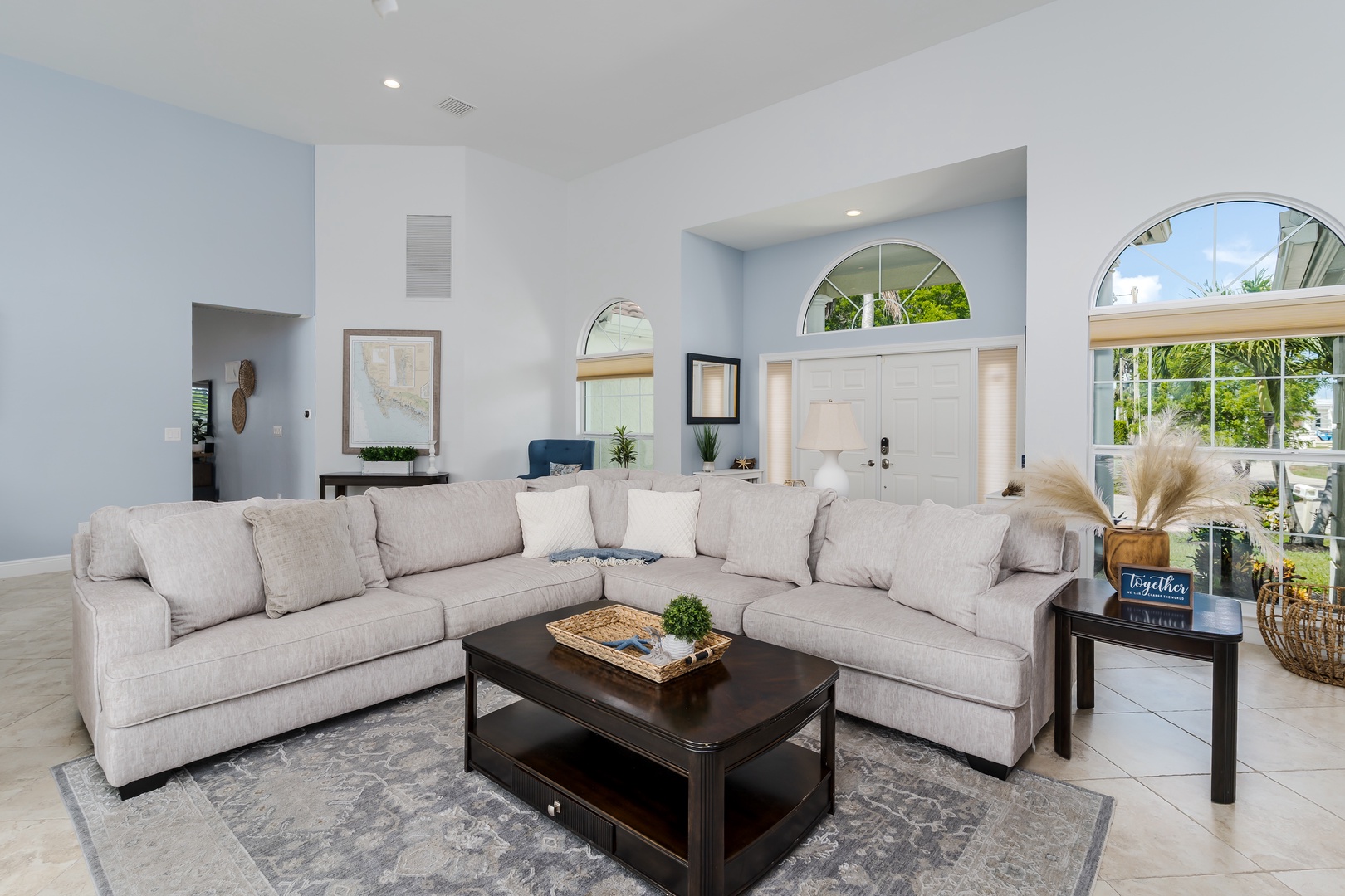 Sink into this spacious sectional sofa where you'll unwind after exploring, surrounded by coastal elegance and natural light.