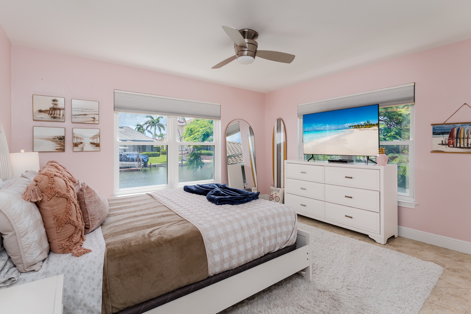 Drift off to sleep in this dreamy pink bedroom, where soft linens meet waterfront views and coastal charm surrounds you.