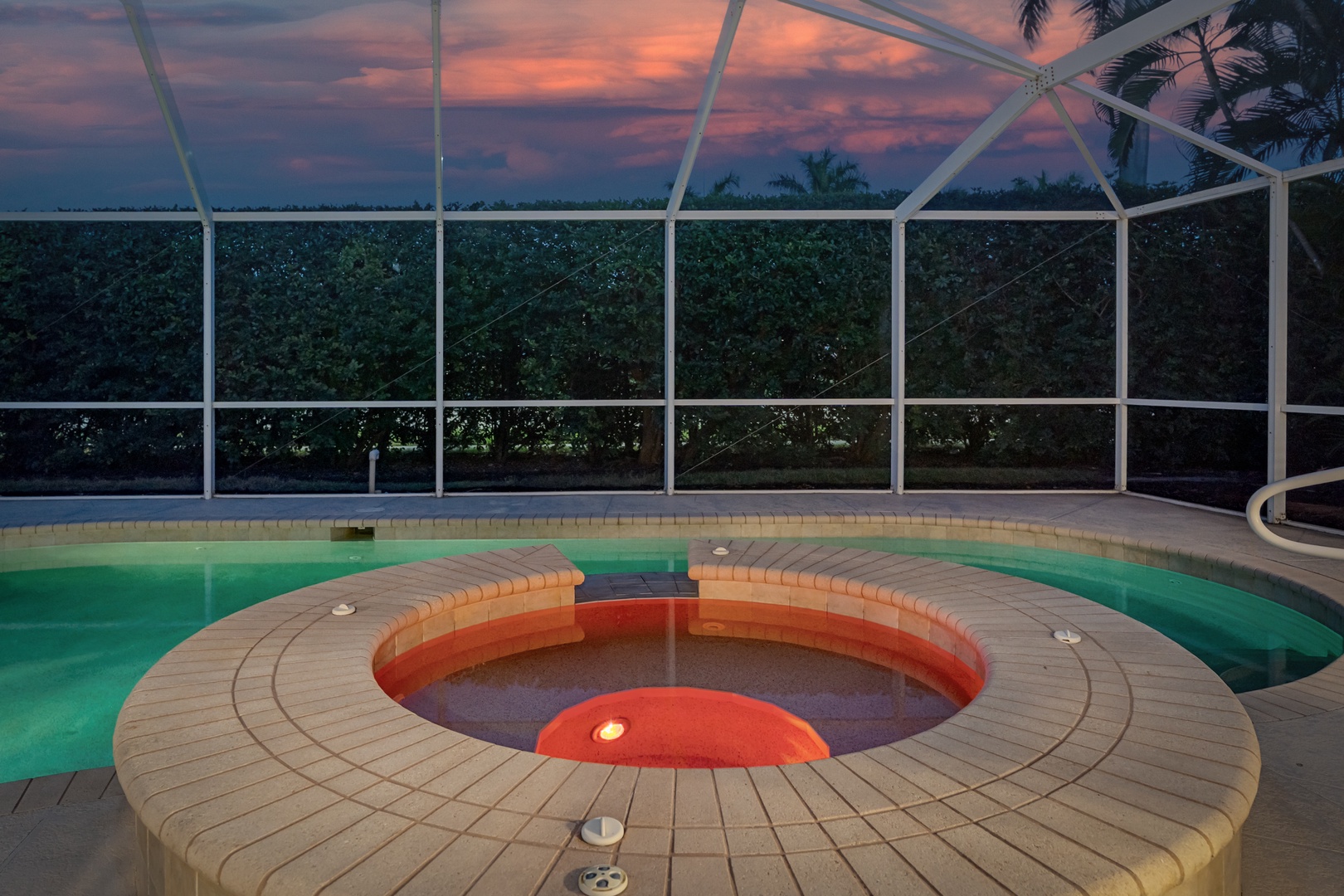 Unwind in your private screened pool area as the sun sets, creating a magical backdrop for evening relaxation.
