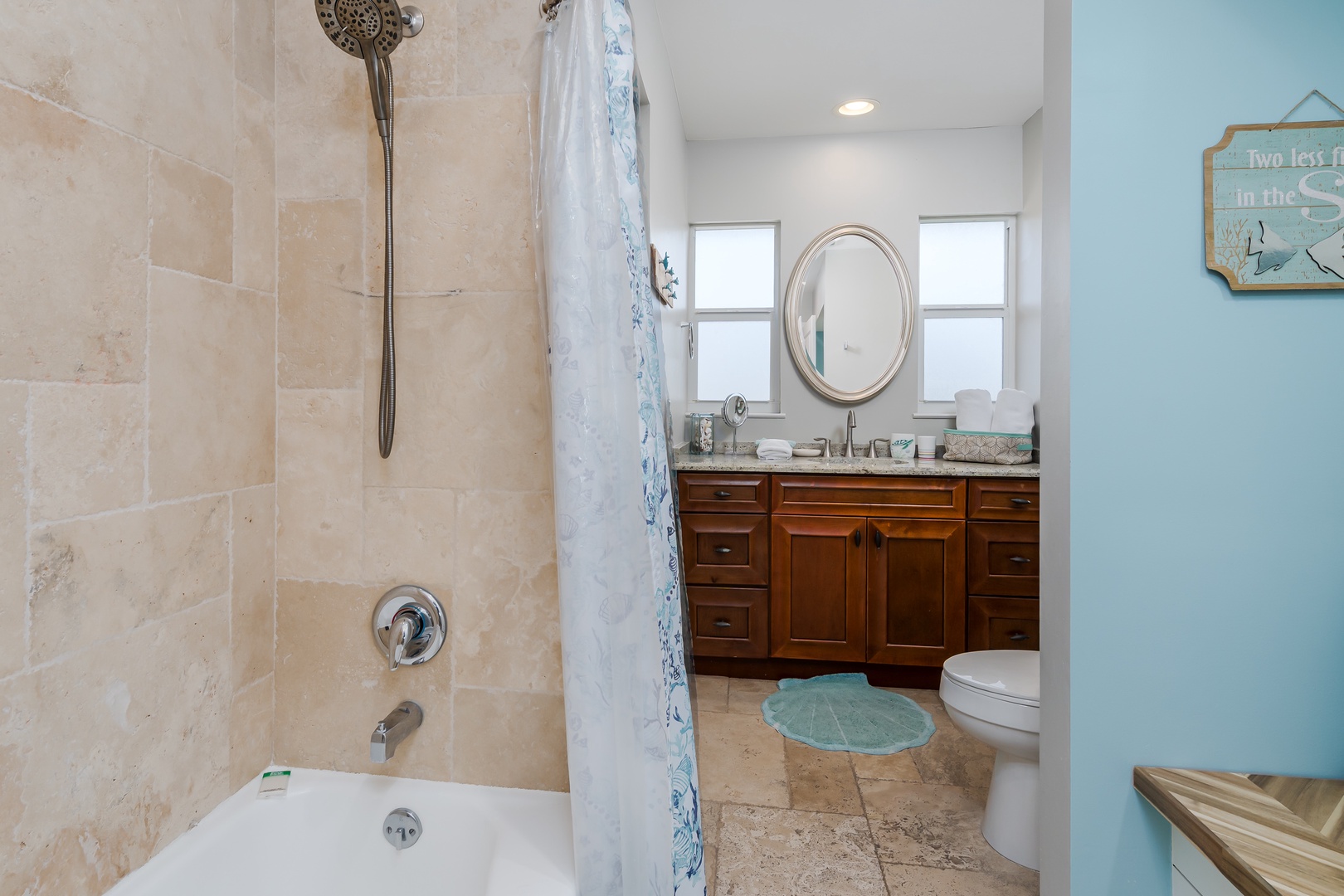 Unwind in your elegant bathroom featuring a soaking tub, walk-in shower, and coastal-inspired touches that create a peaceful retreat.