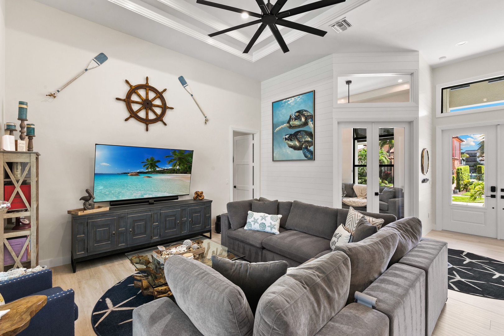 Relax into plush sofas in this coastal-inspired living room, where nautical touches and bright natural light create the perfect atmosphere for unwinding after a day of adventure.