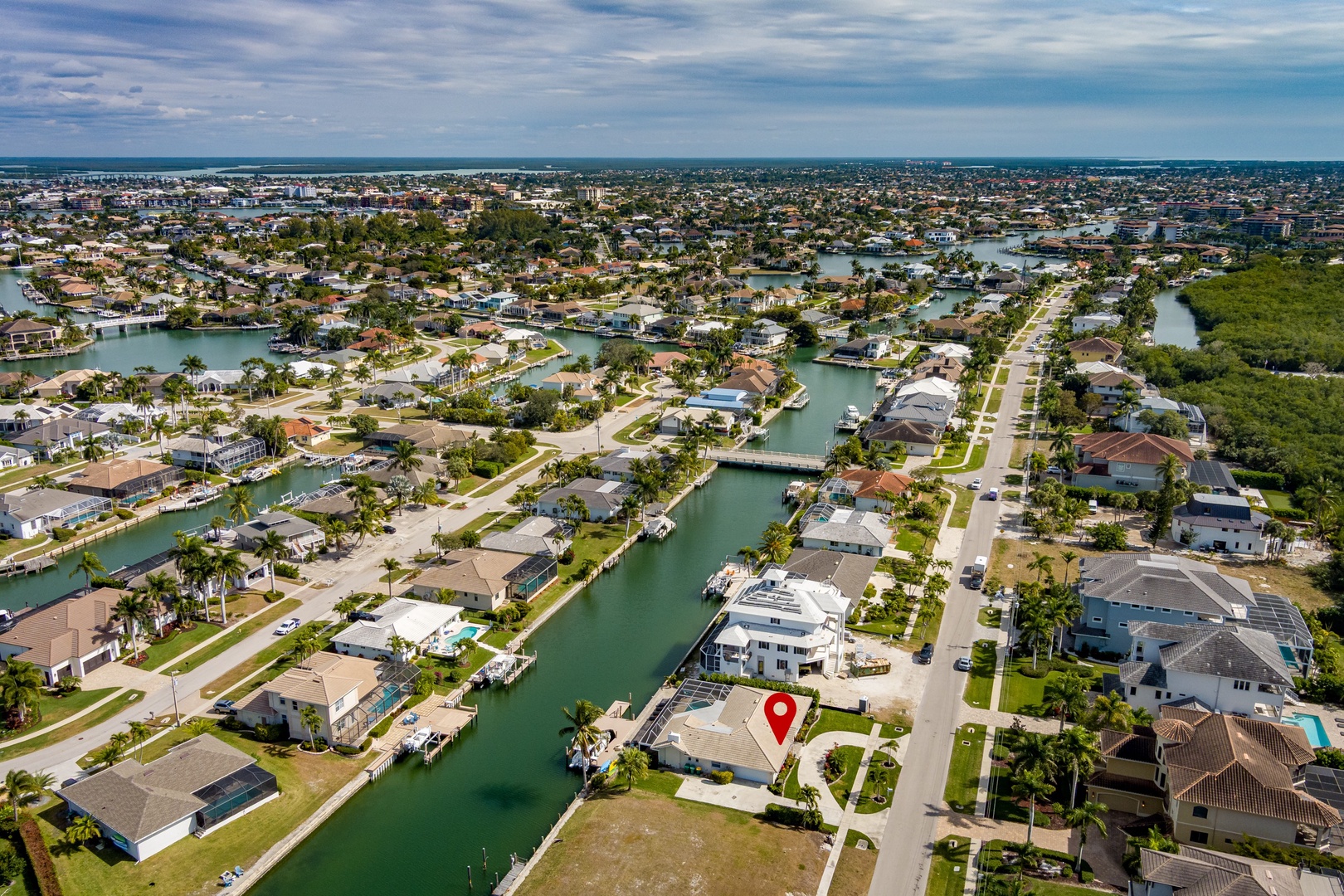 Aerial view of a waterfront community with canal access and boat docks throughout the neighborhood.