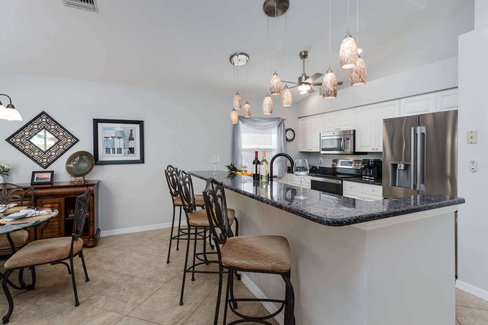 Your modern kitchen awaits with granite counters, stainless appliances, and elegant pendant lighting creating the perfect space for cooking.