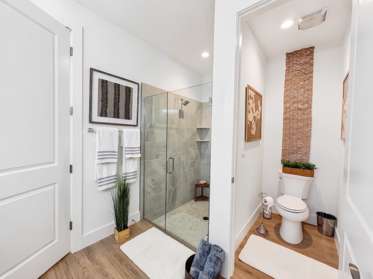Fresh and modern, your bathroom offers a spacious walk-in shower with sleek glass doors, plus a separate toilet area for added privacy. Warm wood tones and thoughtful details create a spa-like feel where you can truly unwind.