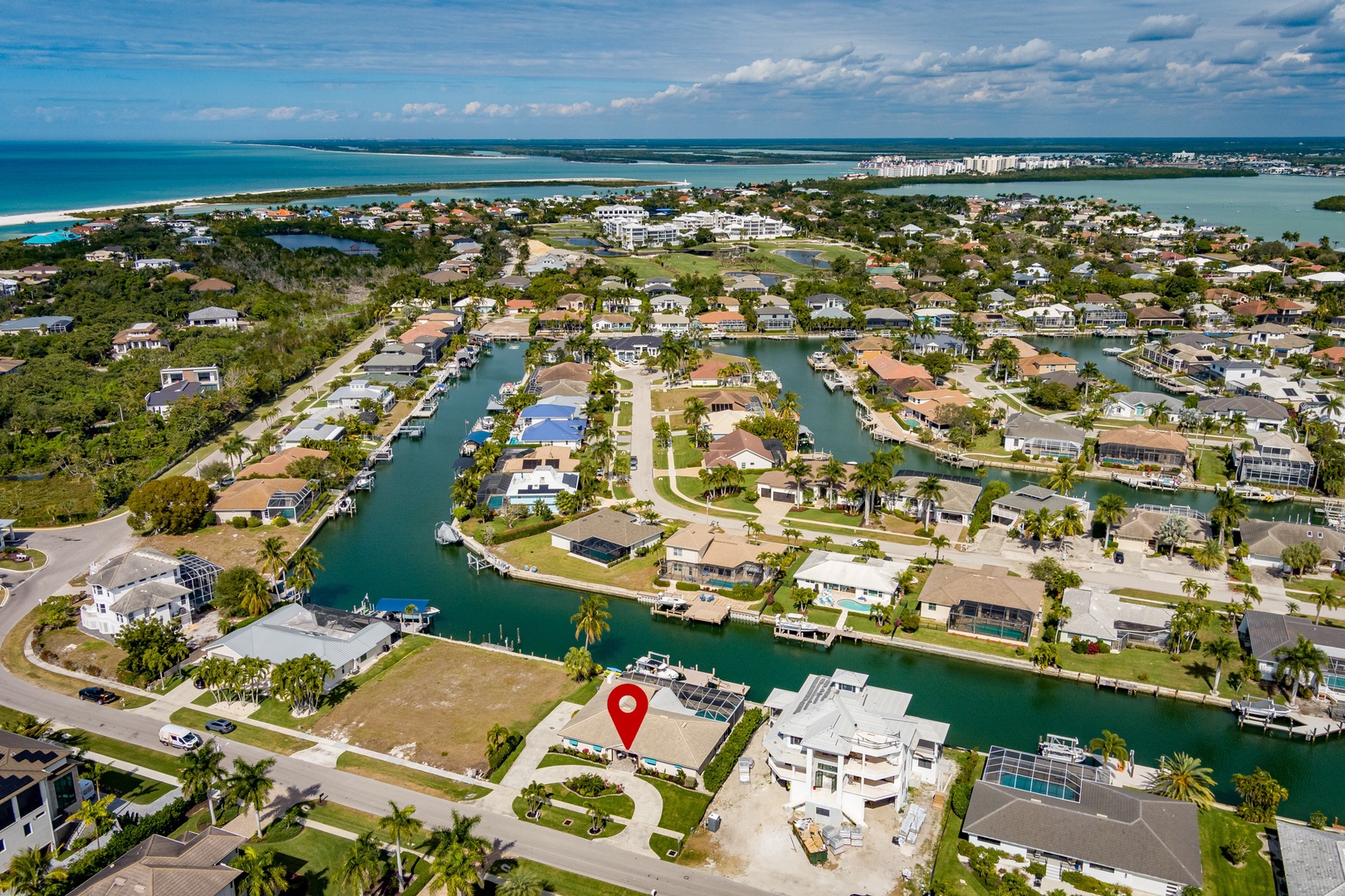 Waterfront coastal community with canal access, featuring residential homes, boat docks, and proximity to beaches and ocean waters.