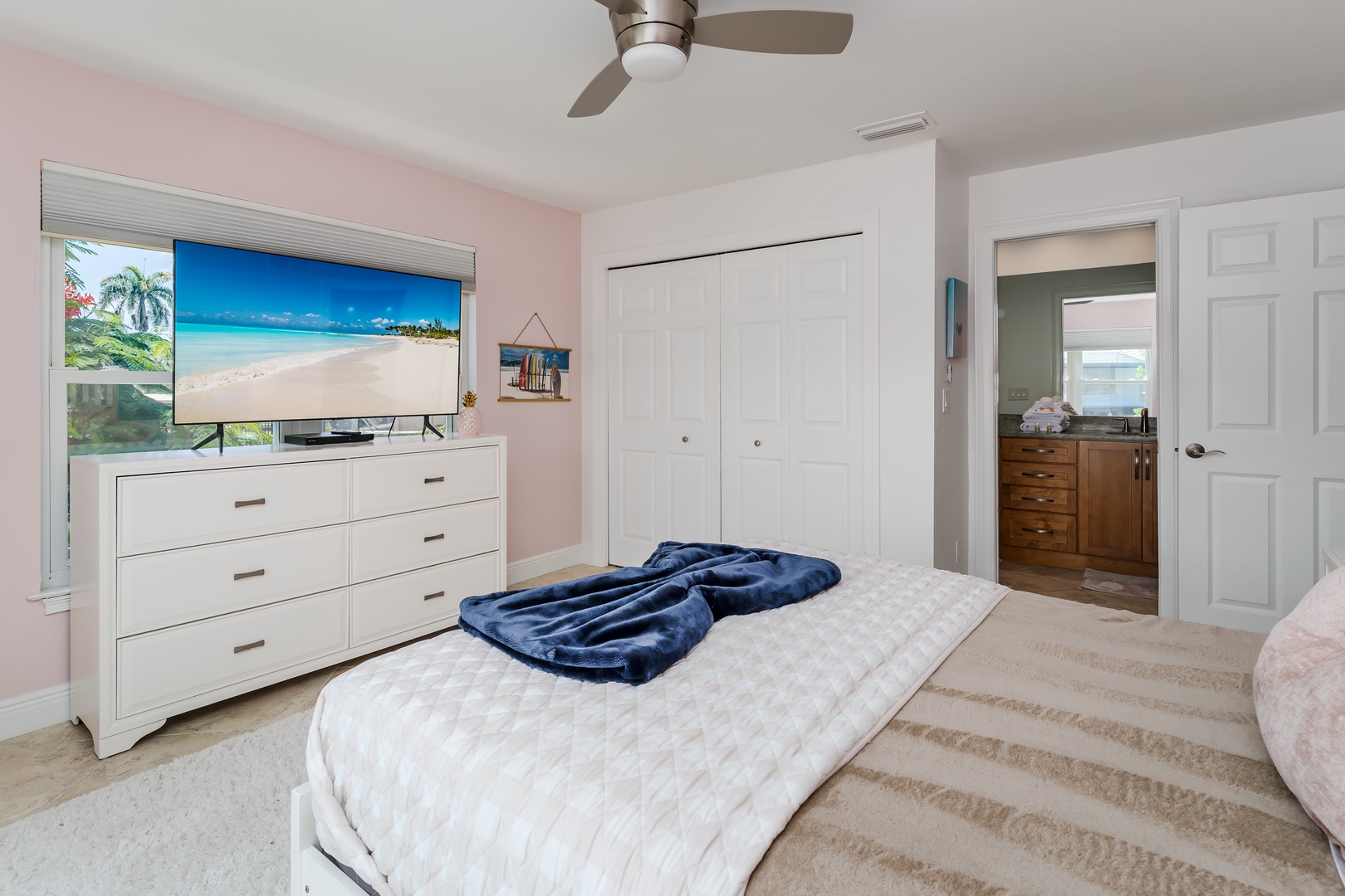 Your bright bedroom features a large TV for movie nights and smart wardrobe storage to keep everything organized during your stay.