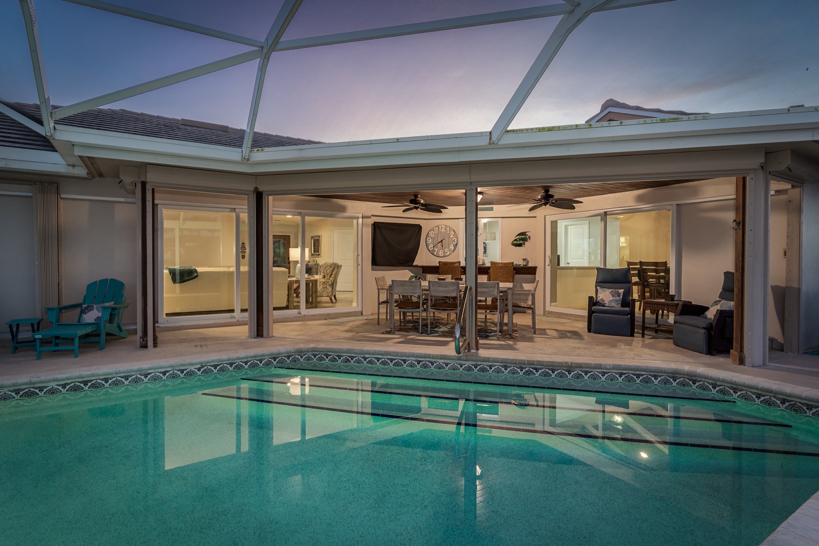 Slip into your private screened pool oasis, where warm evenings blend seamlessly with elegant indoor-outdoor living.