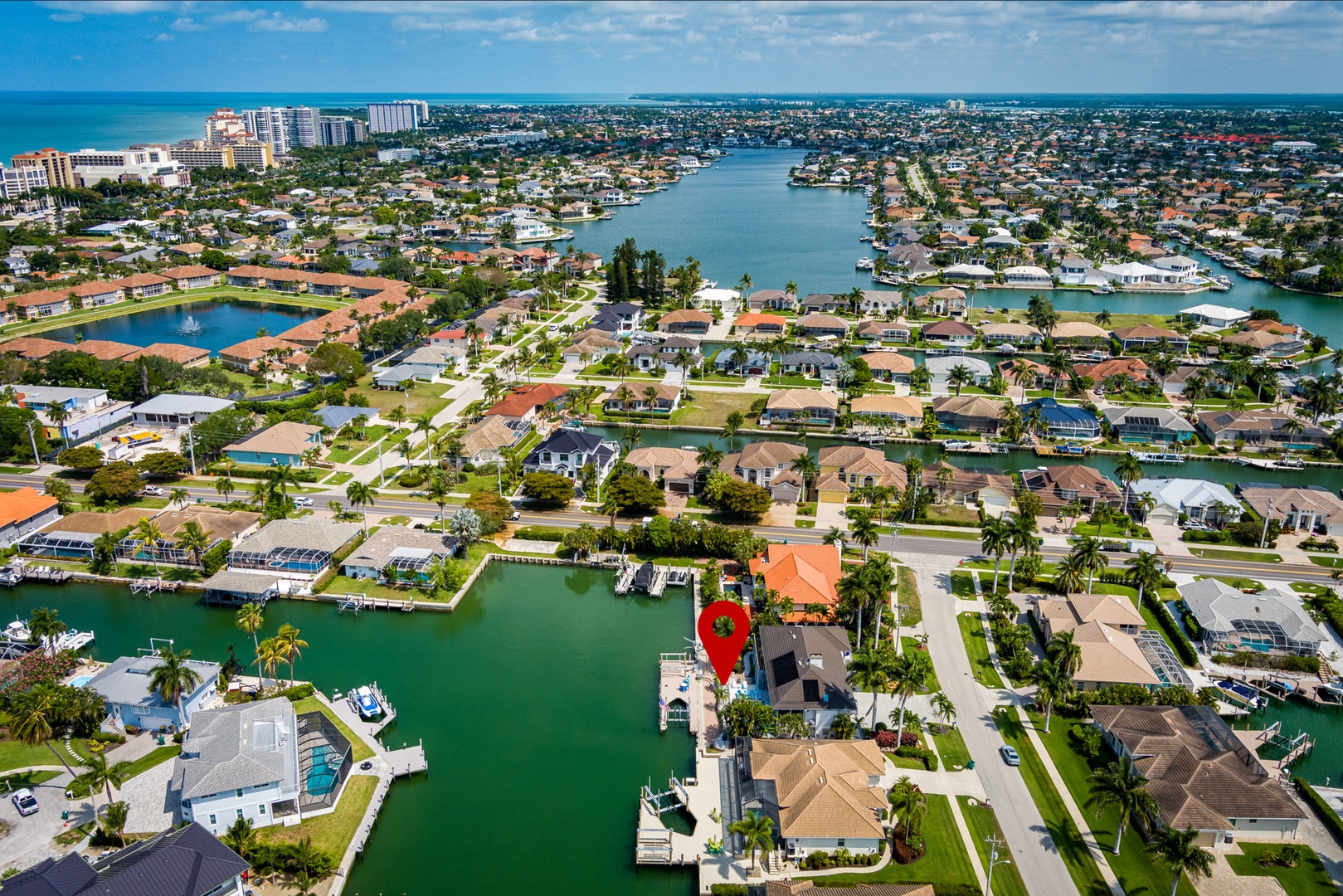 Aerial view of a waterfront residential area featuring canals, docks, and a coastal community with ocean access—ideal for boating enthusiasts and coastal living.