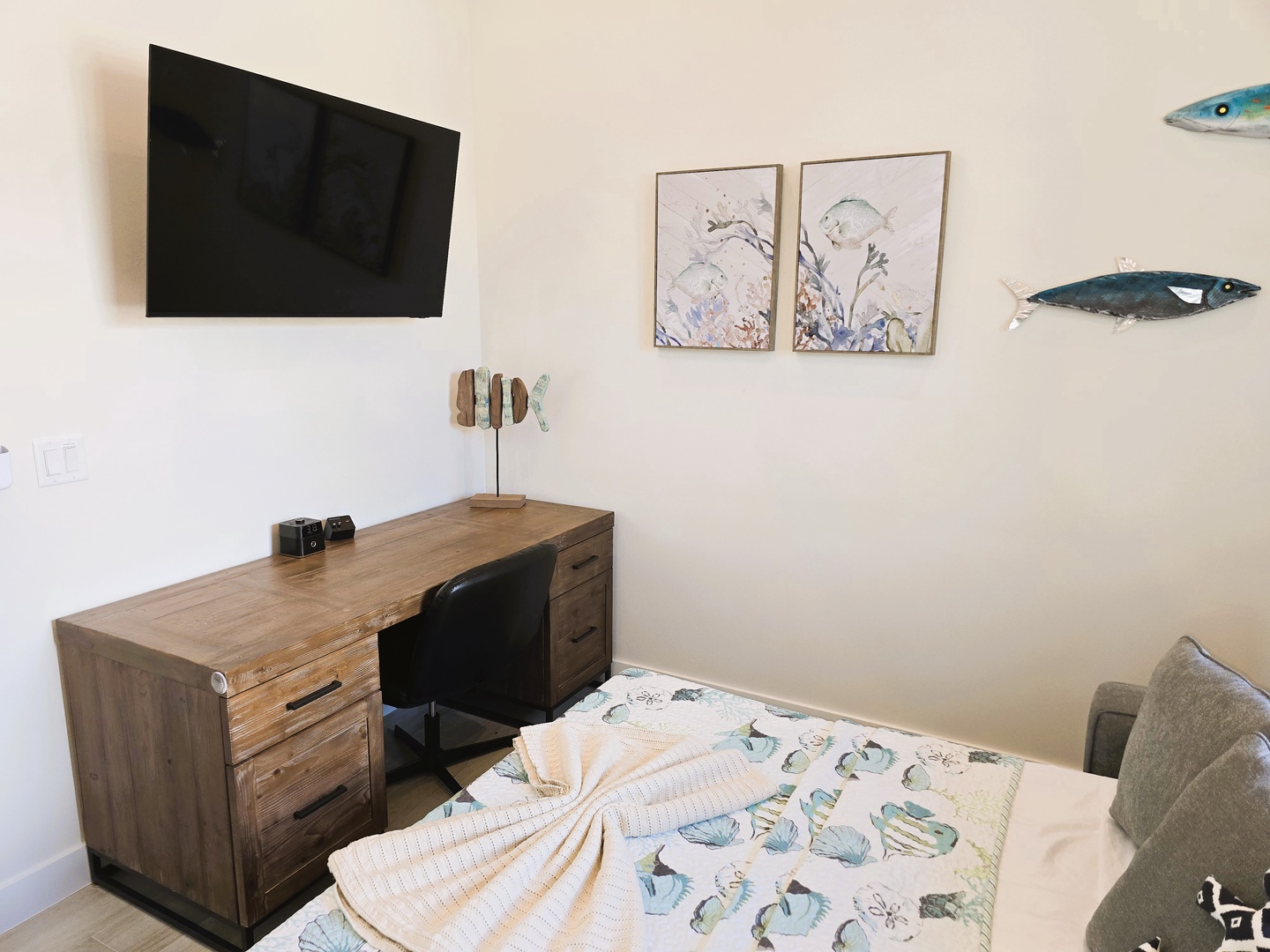 Den to bedroom conversion room (Queen sofa sleeper) pairs coastal charm with modern comforts—a cozy workspace, soft linens with playful fish motifs, and calming artwork invite you to relax and unwind after a day of exploring.