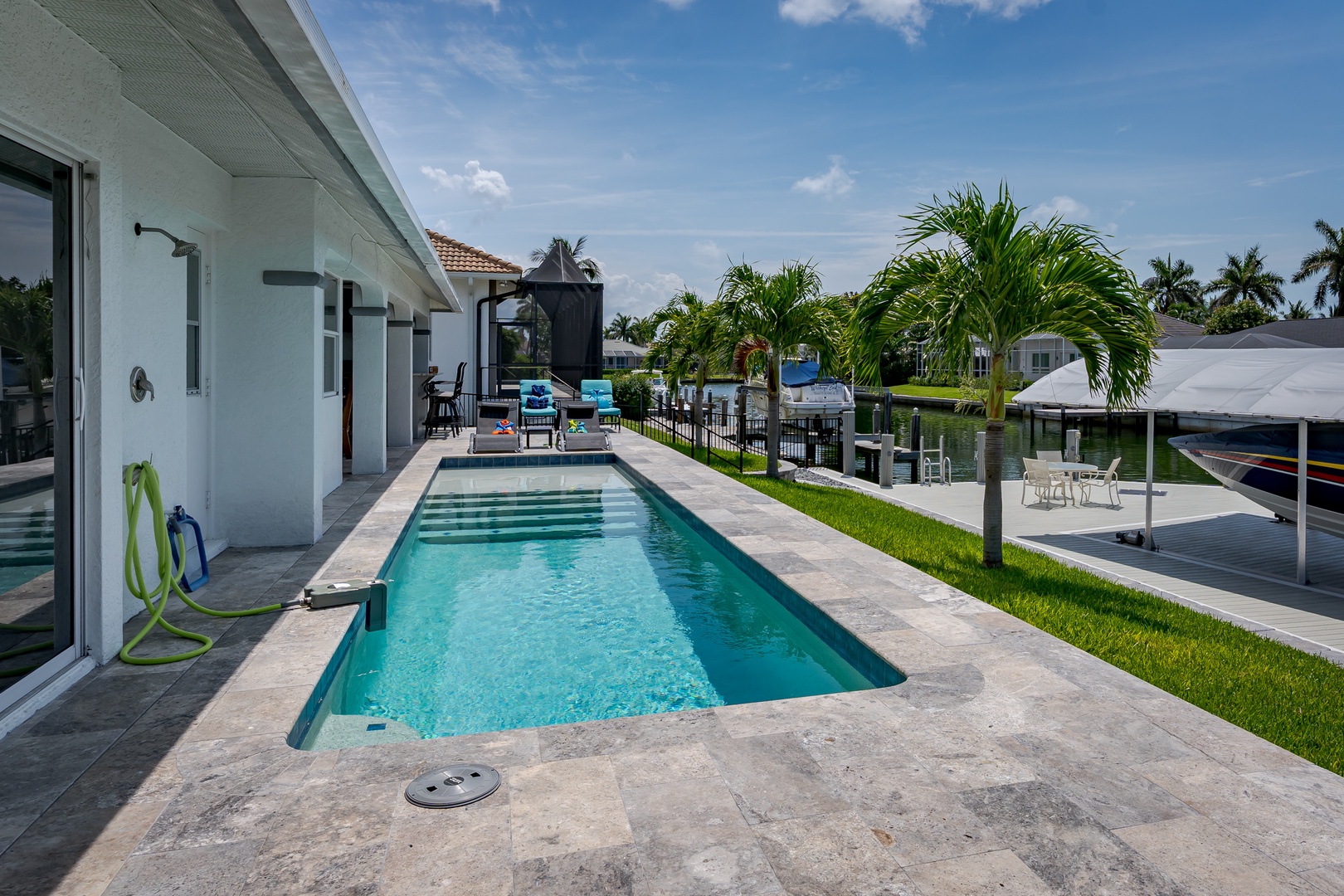 Your private oasis awaits—dive into the sparkling pool, bask in the sunshine, and unwind in this lush, tropical paradise with waterfront views. Perfect for unforgettable moments.