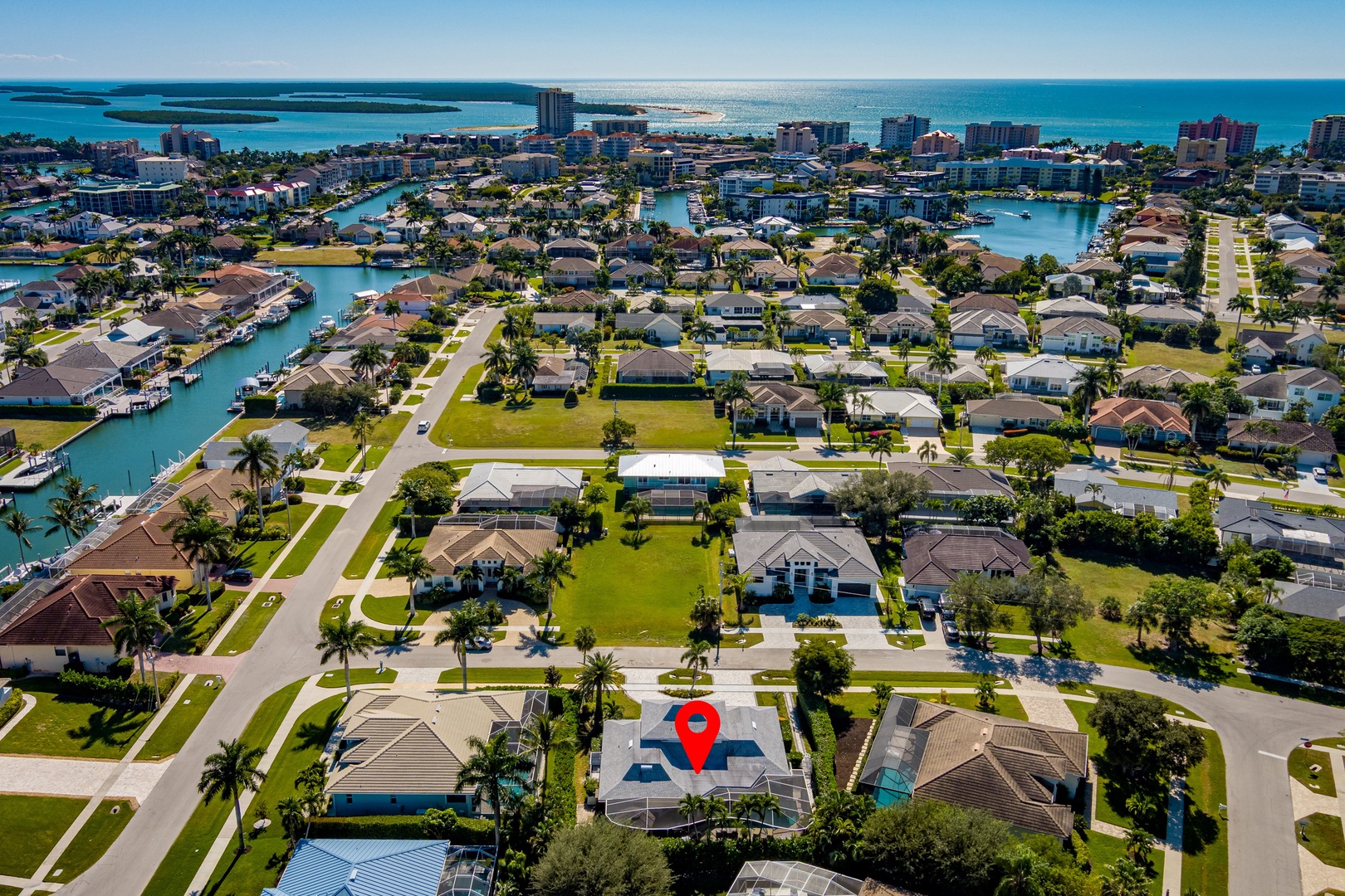 Aerial view of waterfront community featuring residential neighborhoods with canal access and proximity to beaches and city amenities.