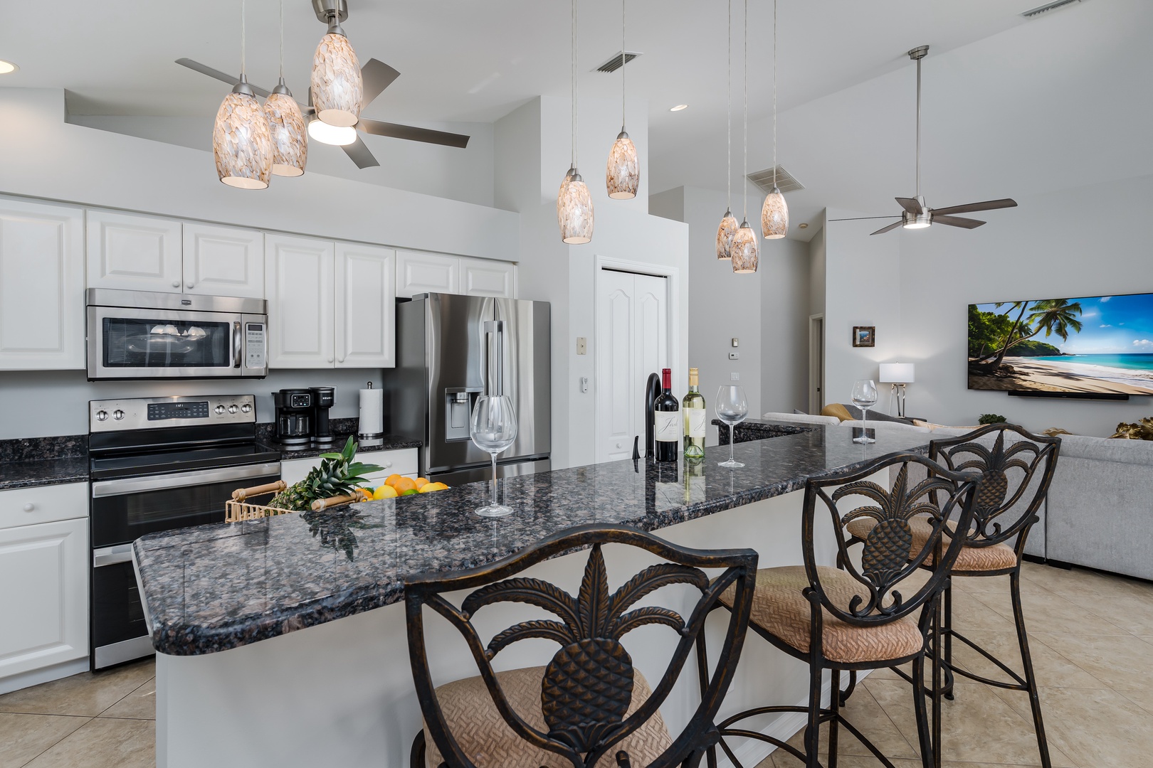 Your gourmet kitchen awaits with granite counters, stainless appliances, and tropical lighting—perfect for preparing beachside feasts.