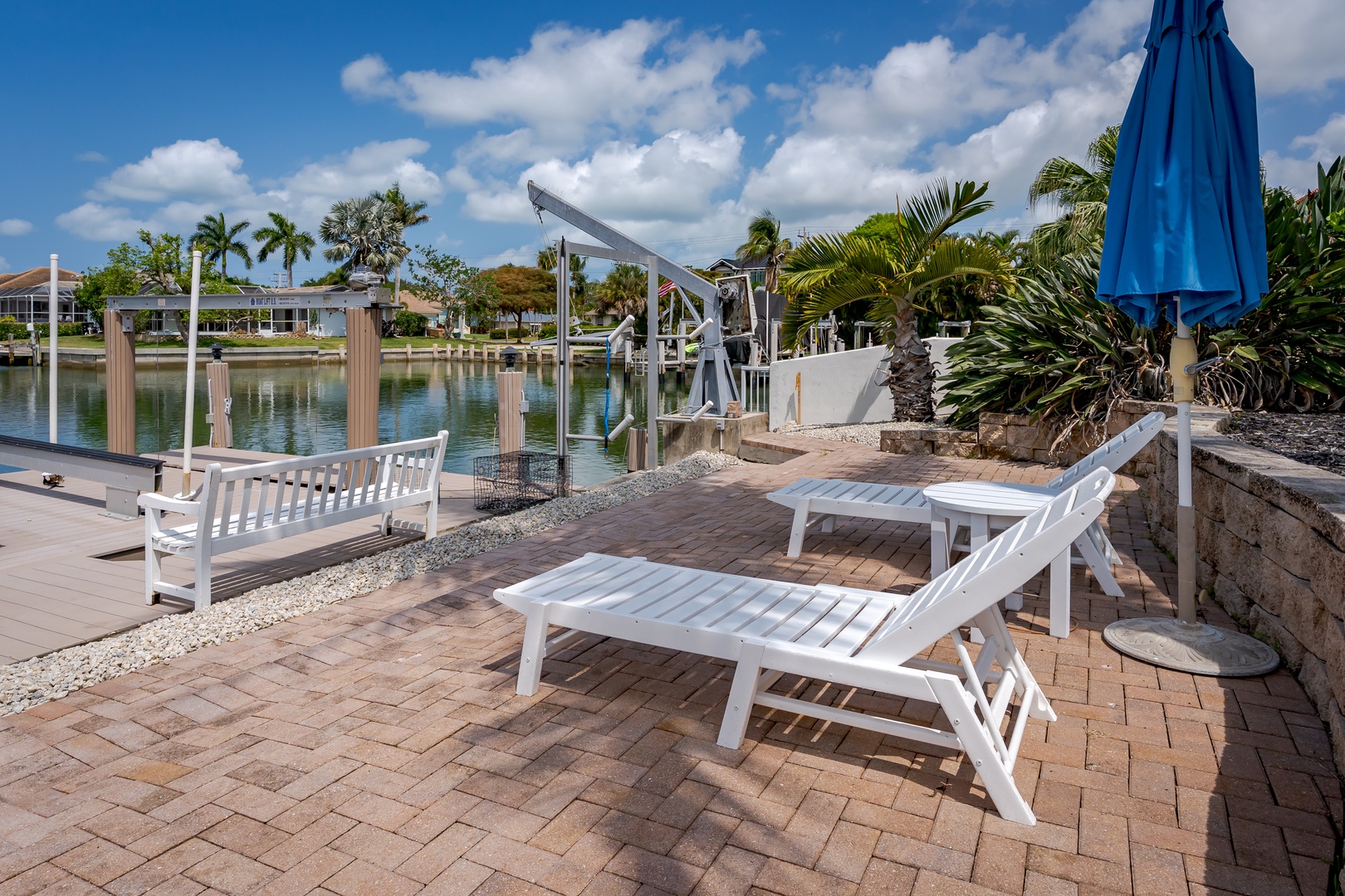 Waterfront haven with private dock, sun loungers, and tropical landscaping in a serene canal setting—perfect for boat lovers and sunshine seekers.