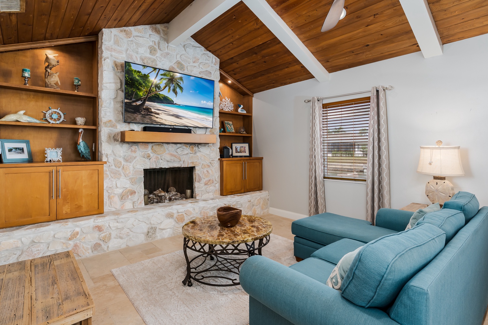 Unwind in your cozy living room with vaulted wood ceilings, stone fireplace, and plush sectional sofa perfect for movie nights.