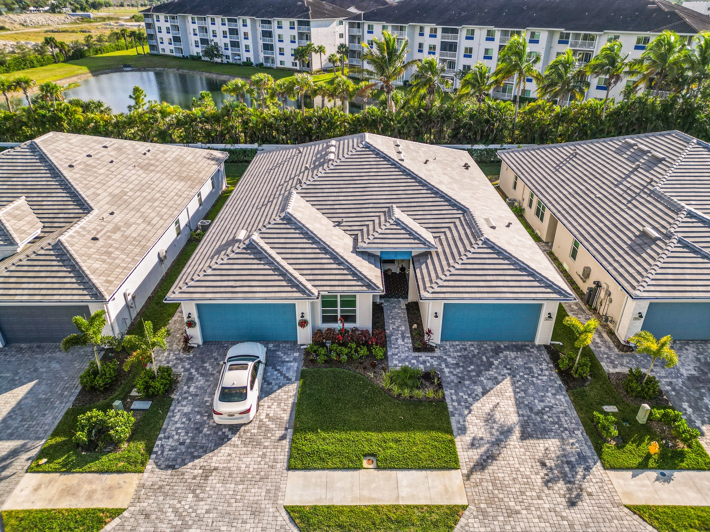 Modern vacation homes in a resort community with lake views and tropical landscaping throughout the neighborhood.