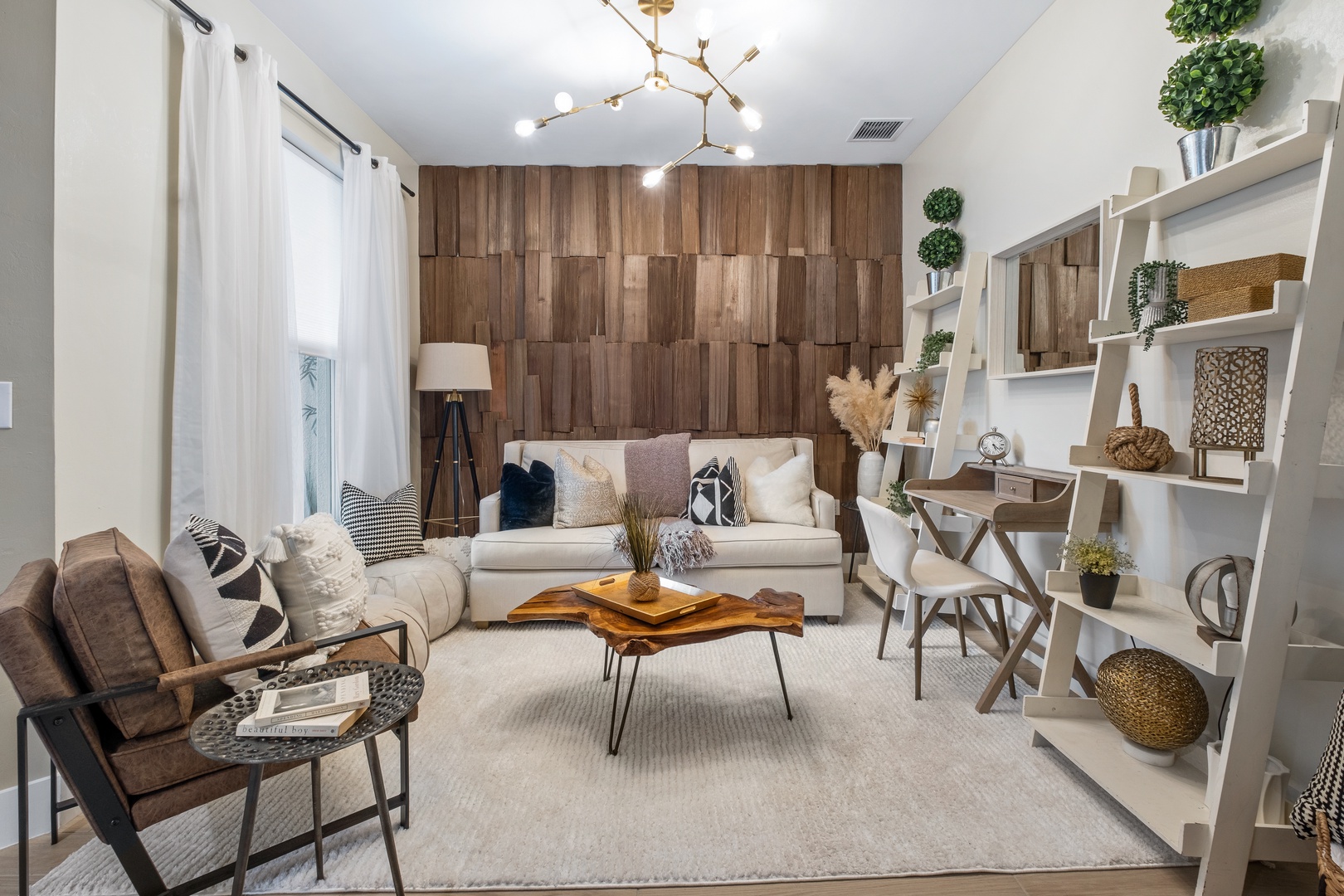 Sink into plush seating surrounded by warm wood tones and curated decor, where your morning coffee tastes better in this thoughtfully designed retreat.