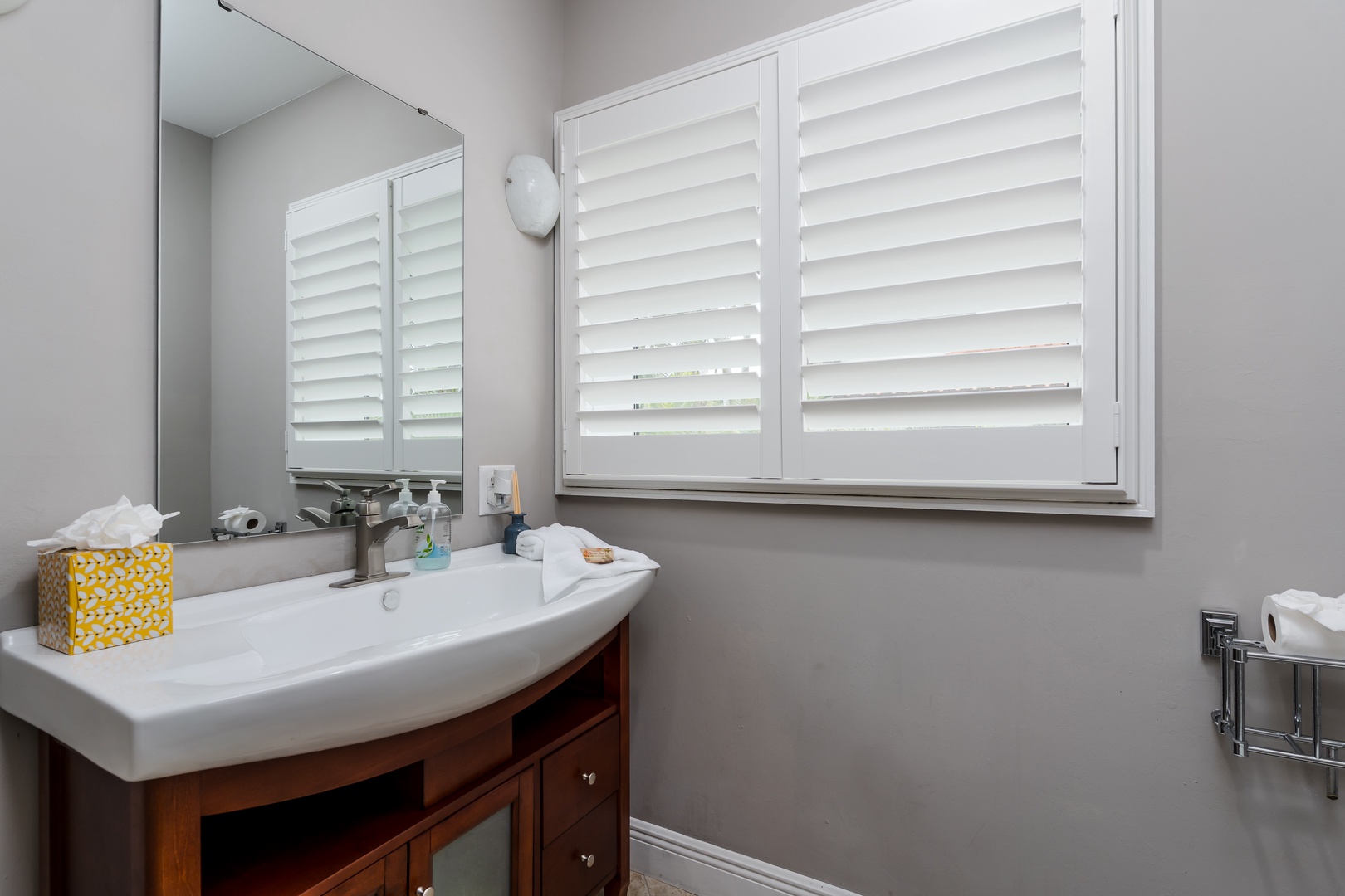 Freshen up in your private bathroom with a sleek vanity, stylish mirror, and thoughtful touches like soft towels and hand soap ready for your arrival.