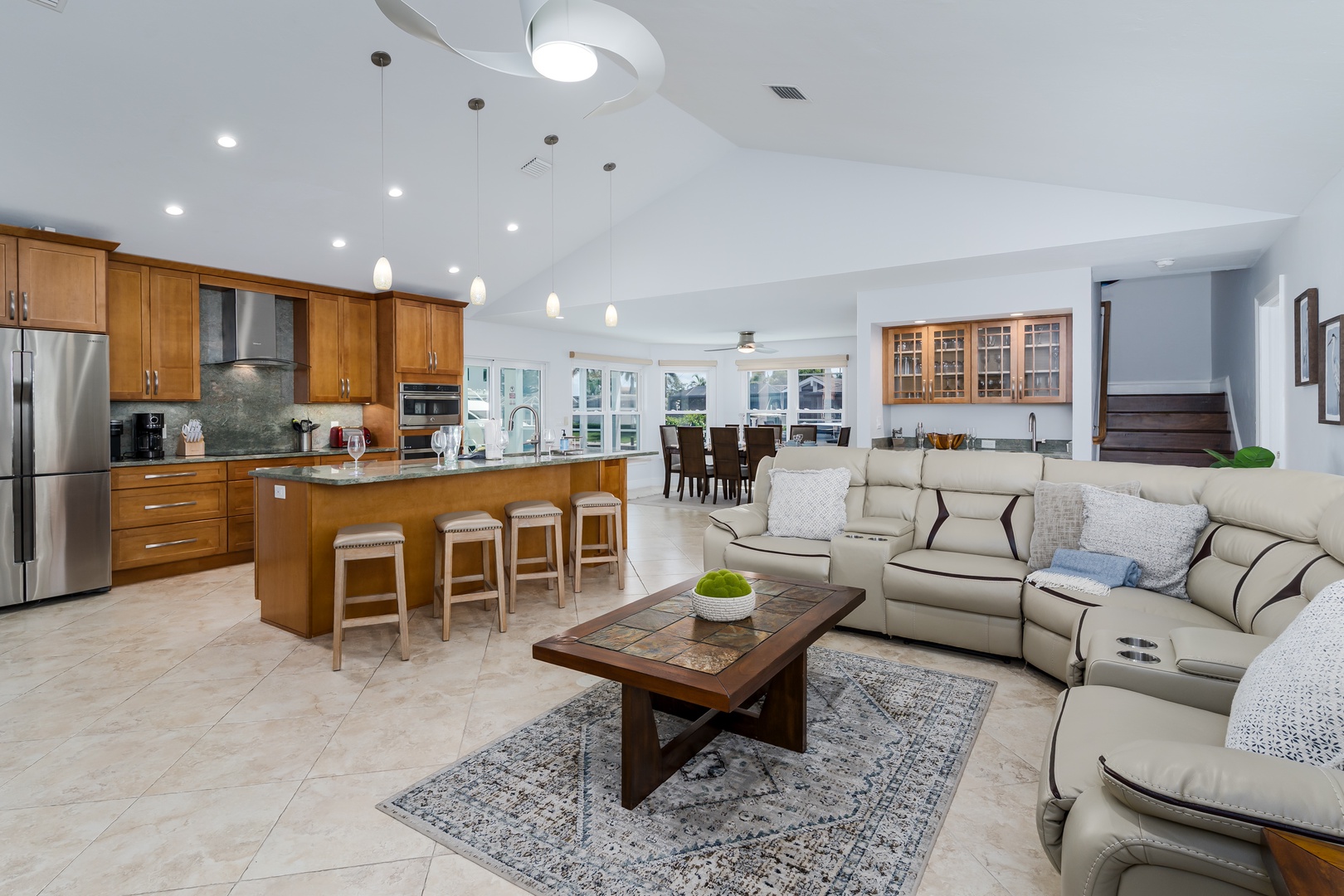 Your open-concept haven seamlessly blends a spacious kitchen with granite counters, sectional seating, and dining space for memorable gatherings.