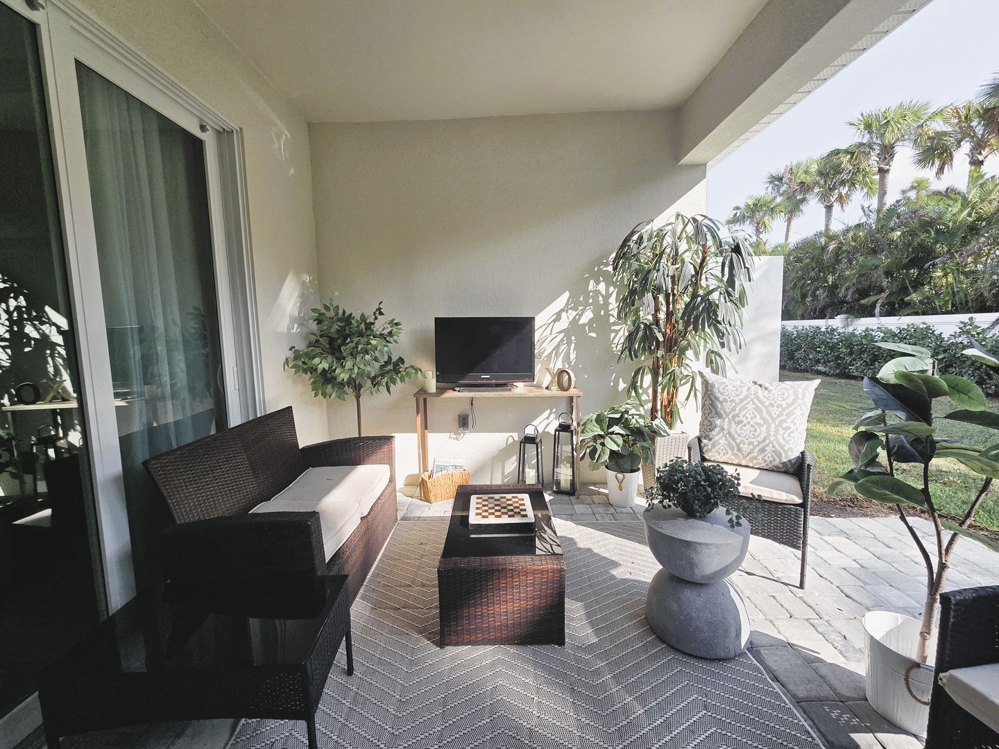 Step onto your private terrace where comfortable seating awaits among lush plants, creating the perfect spot for morning coffee or evening relaxation.