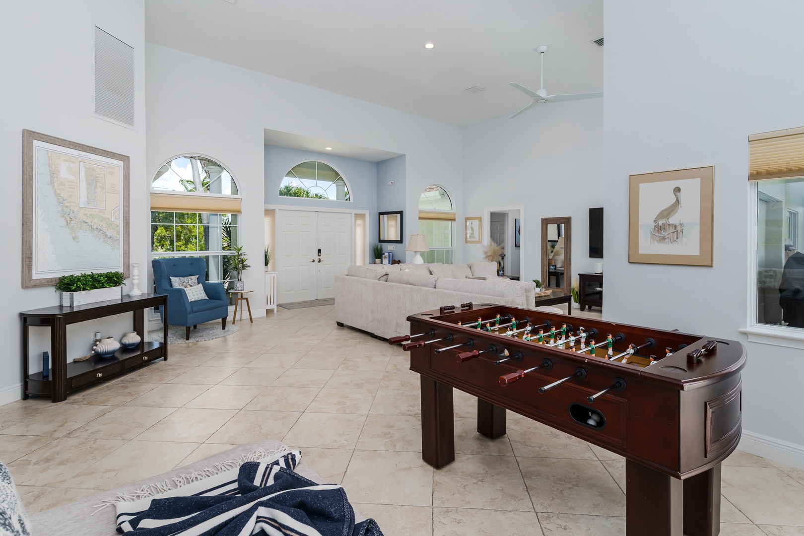Your spacious living room combines comfort with entertainment, featuring a foosball table for friendly competition and elegant seating for relaxation.
