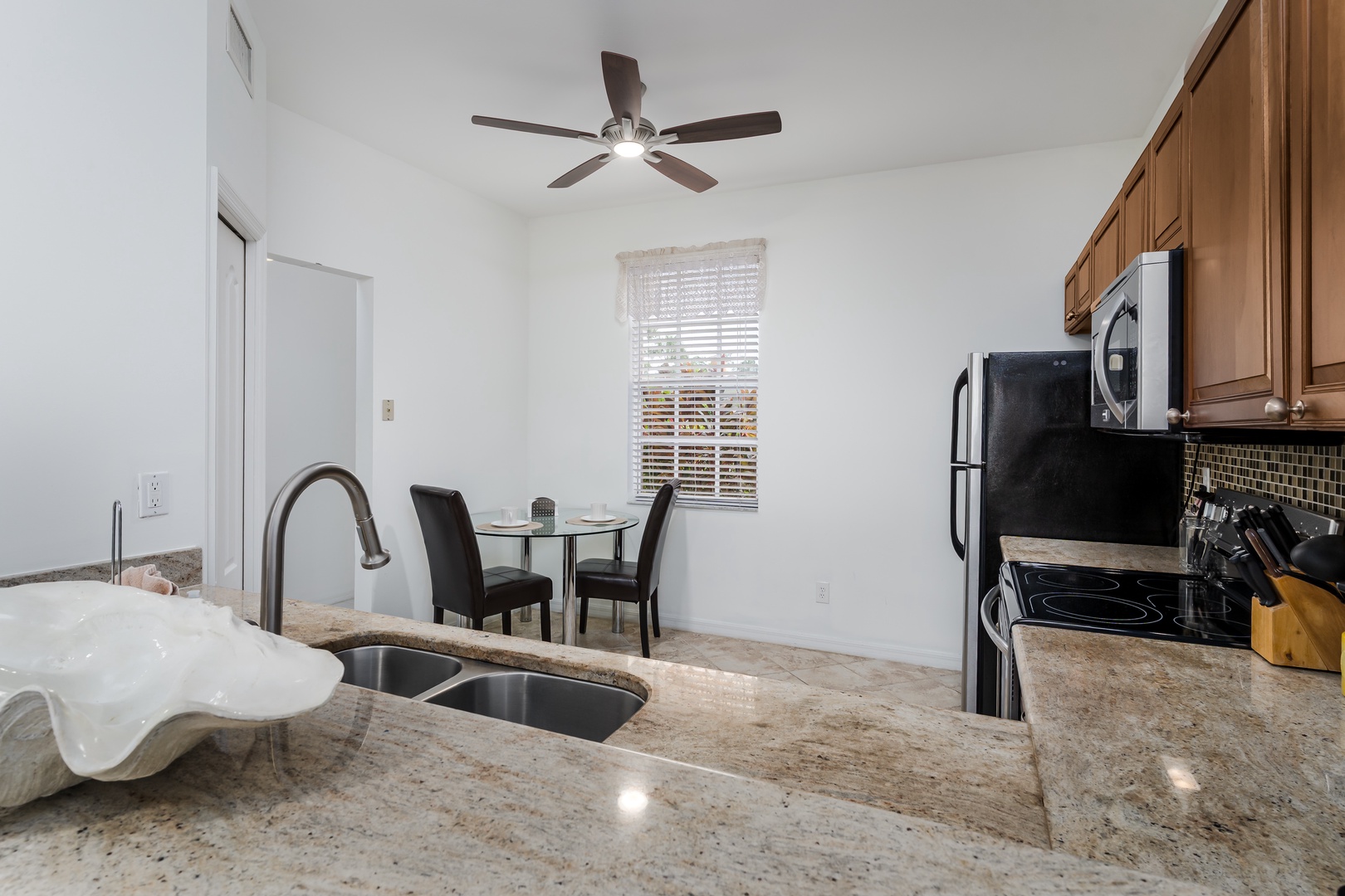 Your fully equipped kitchen features granite countertops, modern appliances, and a cozy dining nook—perfect for preparing home-cooked meals and enjoying relaxed mornings together.