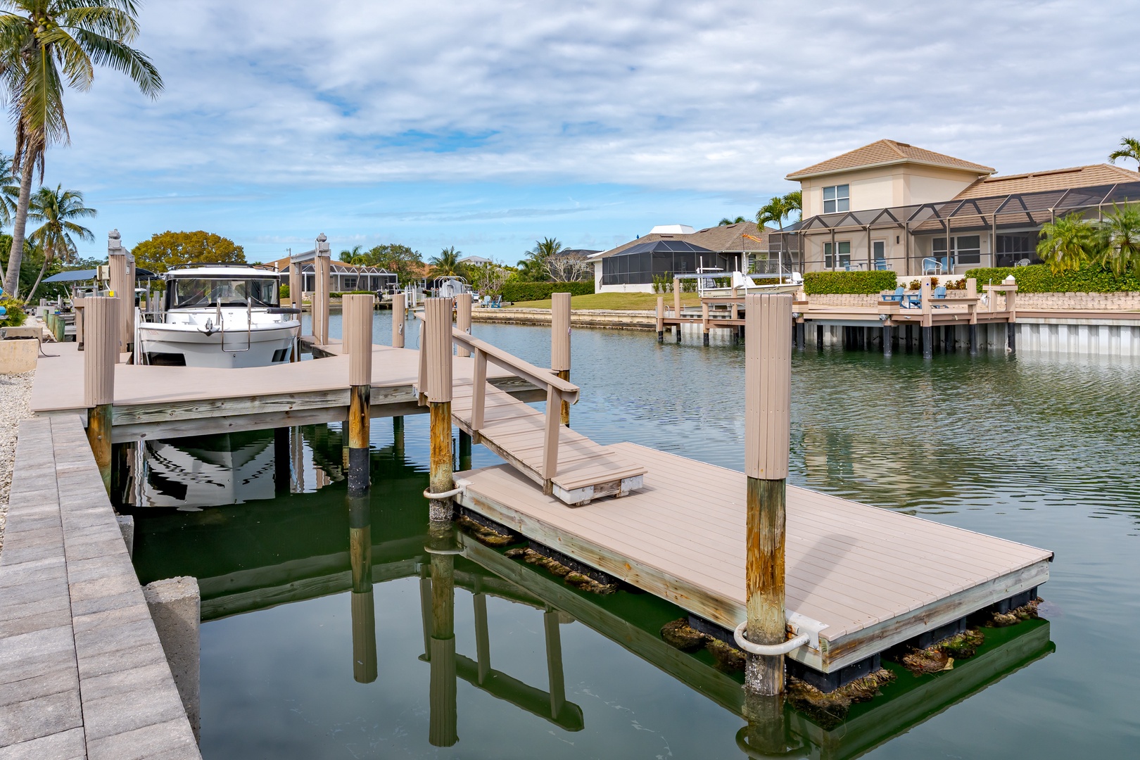 Waterfront community features private boat docks and canal access surrounded by tropical landscaping and luxury homes.