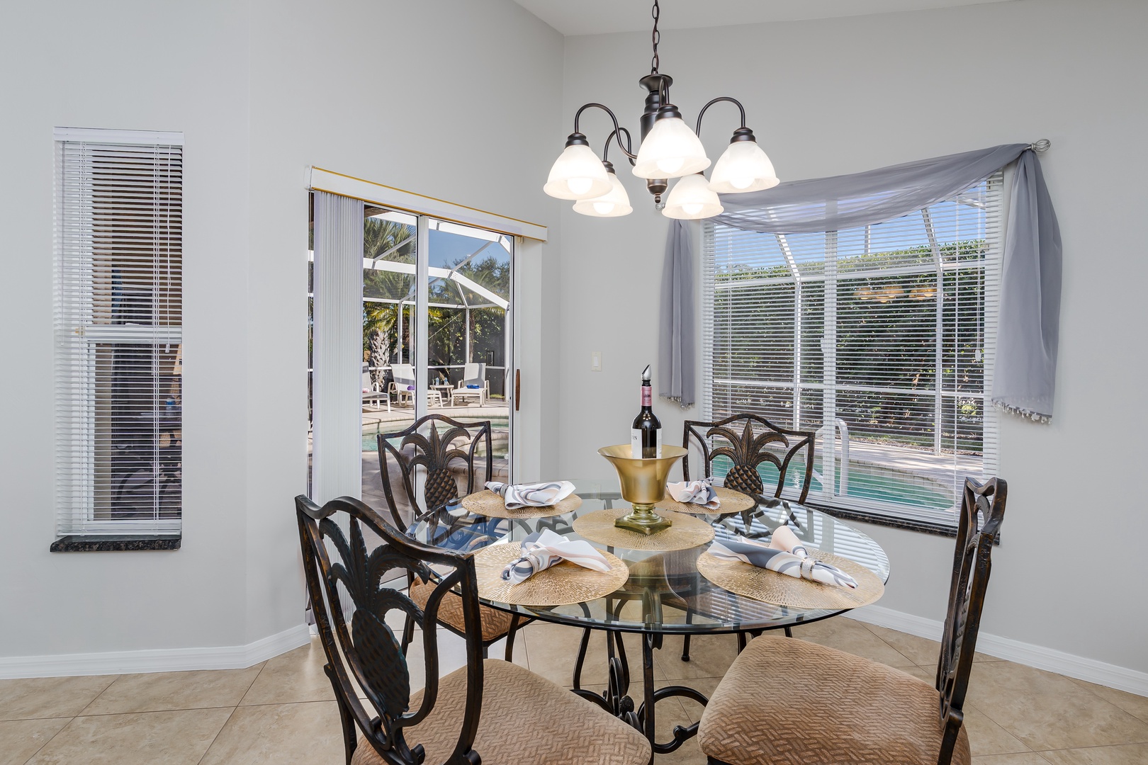 Gather around this elegant dining table where memorable meals await, with stunning pool views creating the perfect backdrop for your vacation dining.
