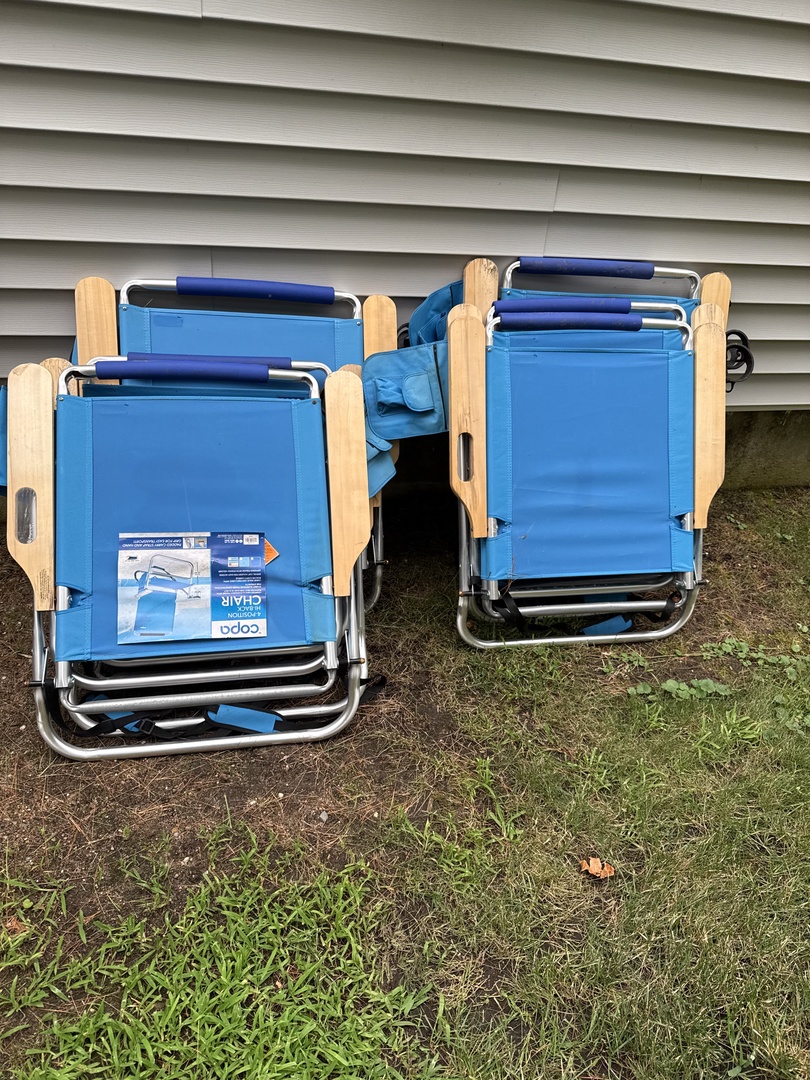 Folding beach chairs sit ready for your next outdoor adventure, waiting to be grabbed for a day of lakeside relaxation or backyard lounging.