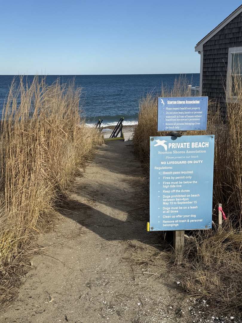 Private beach access with clear sandy pathway leading to pristine waters.