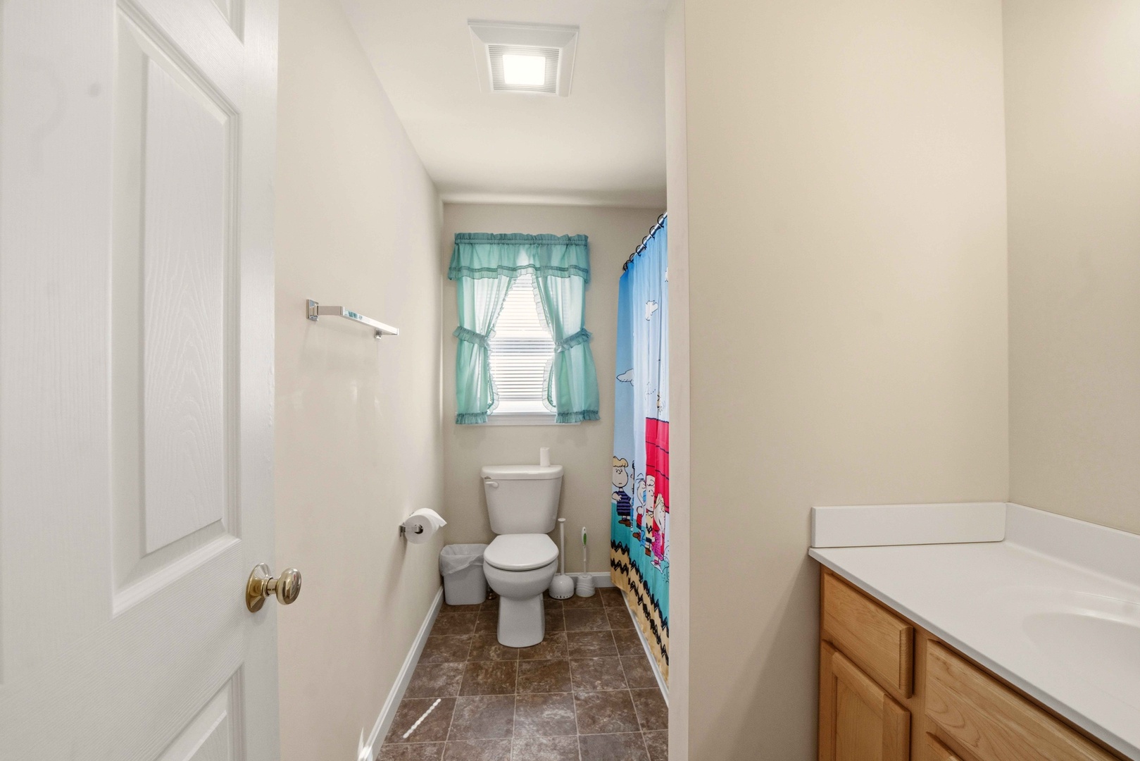 Your private bathroom features clean lines and thoughtful details, with cheerful curtains adding warmth to your daily routine.