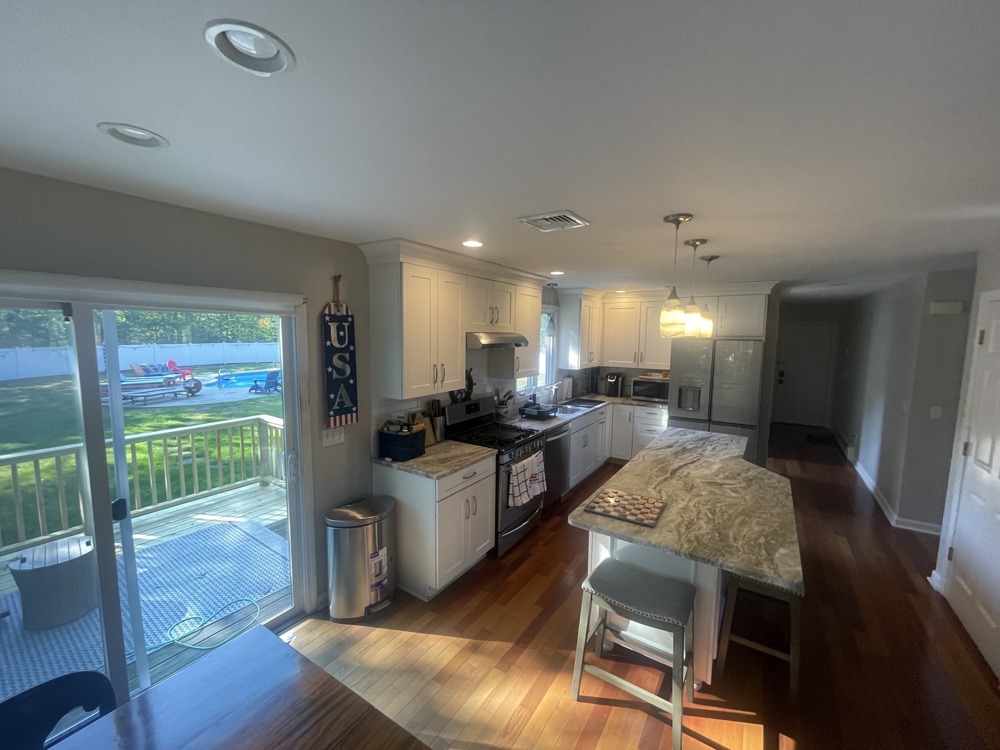 Your spacious kitchen features granite countertops, stainless steel appliances, and warm hardwood floors. Step onto the private deck for morning coffee or evening relaxation.