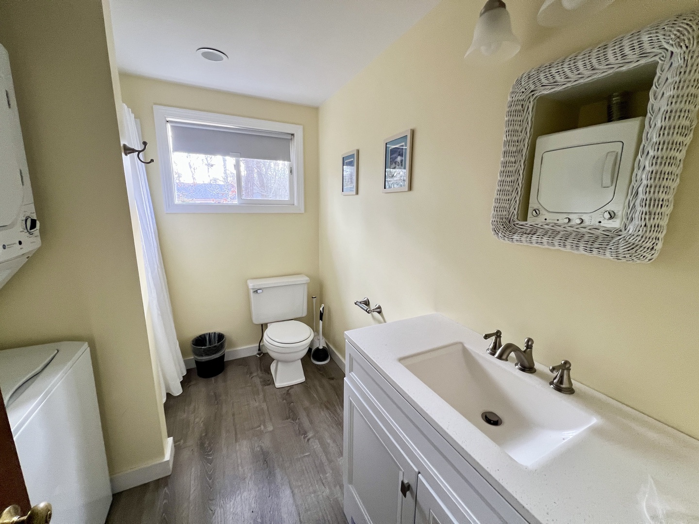 Freshen up in your bright, thoughtfully appointed bathroom featuring warm yellow walls and modern fixtures for your comfort.