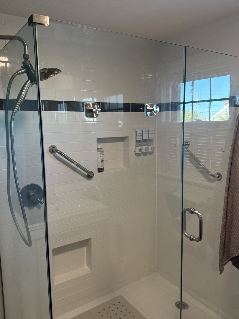 Step into your modern glass-enclosed shower where rain showerheads and sleek fixtures create a spa-like retreat for refreshing moments.