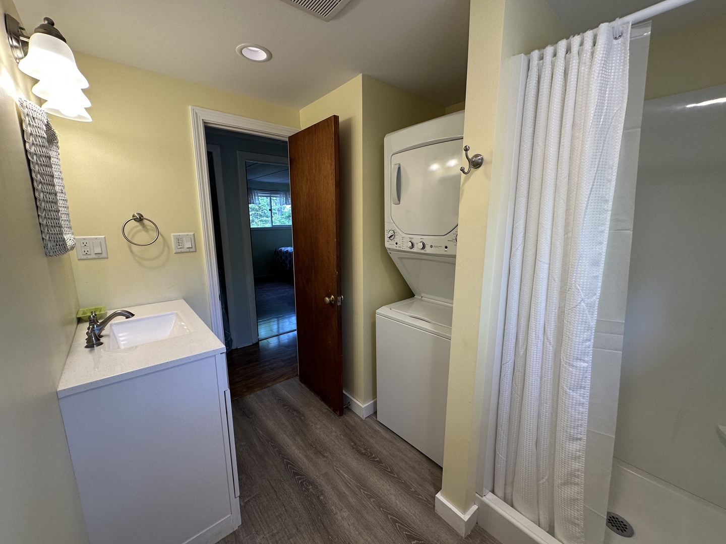 Your ensuite bathroom features a spacious shower, vanity, and convenient in-unit washer/dryer combo for effortless stays.