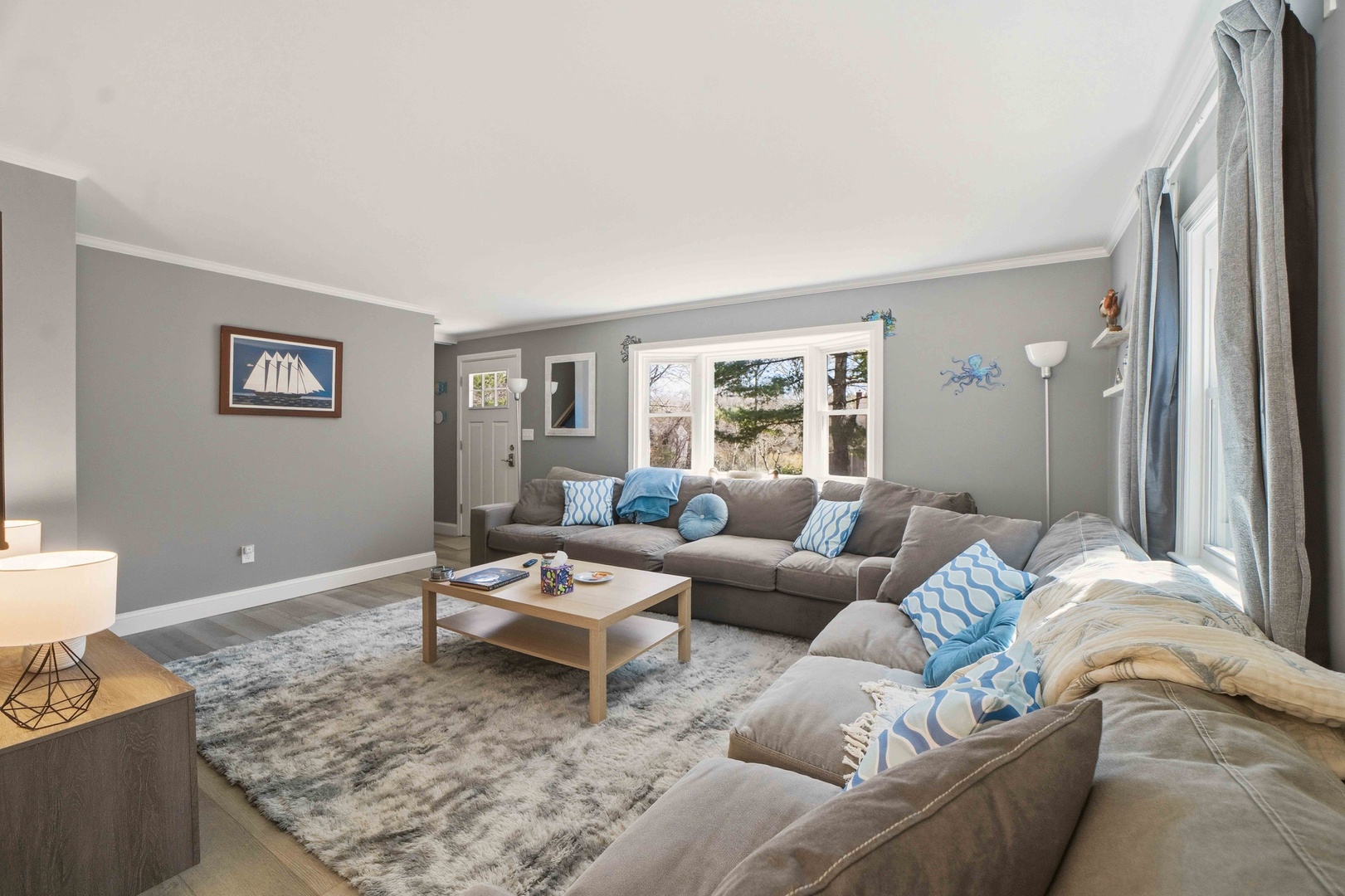 Sink into plush seating with ocean-inspired touches and natural light streaming through large windows for your perfect relaxation retreat.