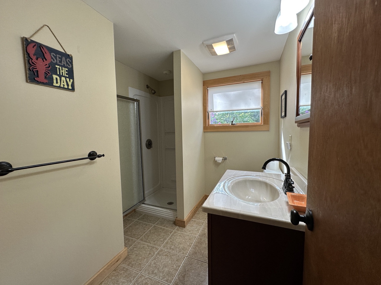Your spacious bathroom features a glass-enclosed shower and stylish vanity for your comfort.