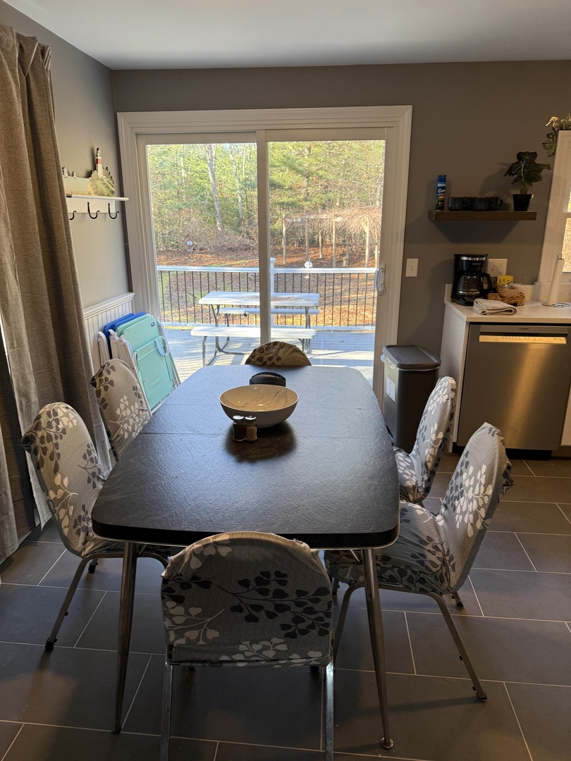 Your dining nook awaits with elegant table settings and natural light streaming through windows.