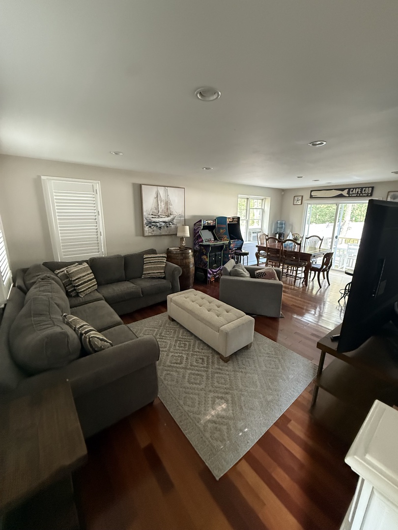 Sink into plush sofas in your bright living space, where warm hardwood floors and modern comfort create the perfect spot to unwind after exploring.