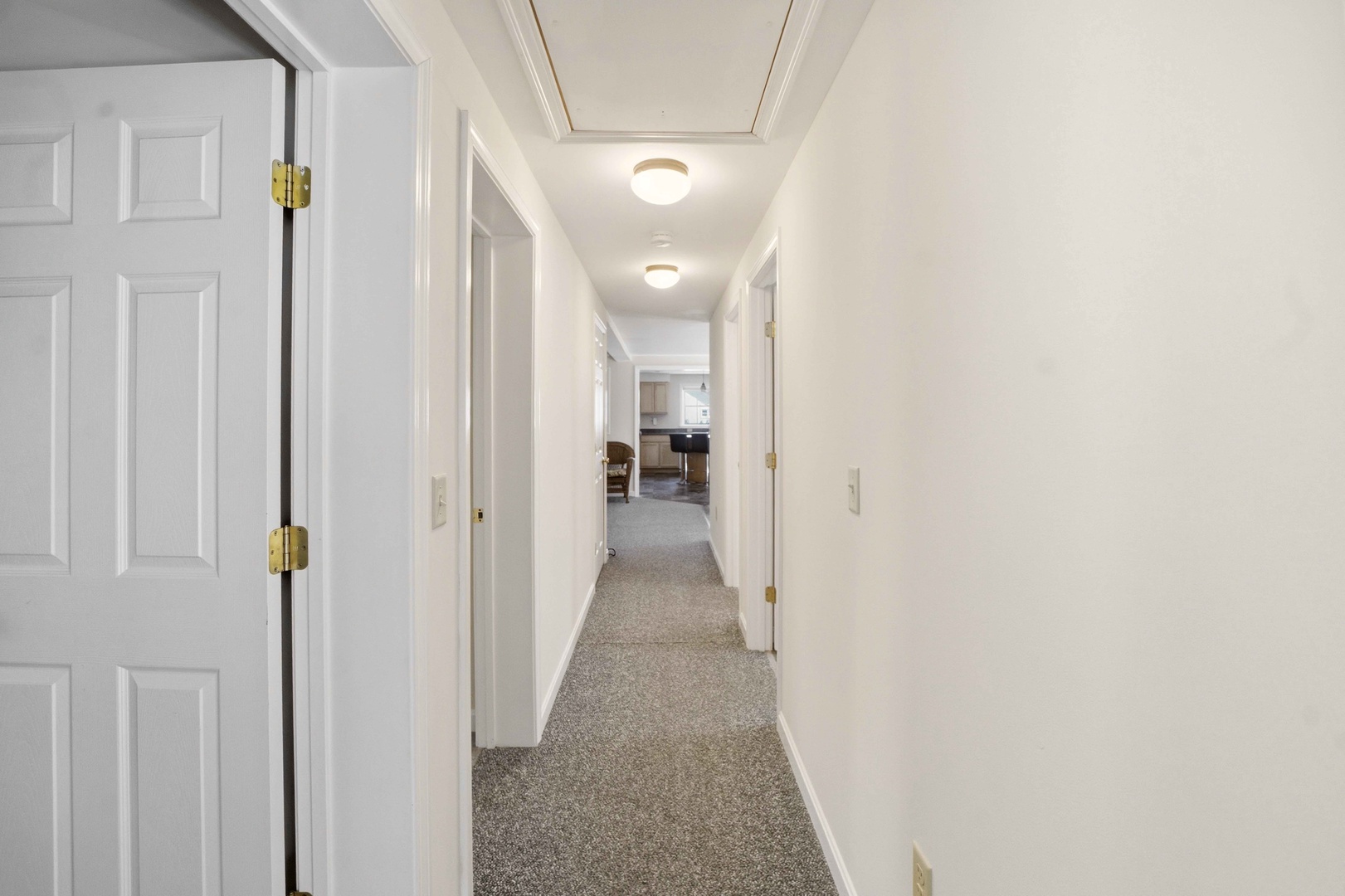 A welcoming hallway connects your private spaces to the heart of your vacation home, with soft lighting guiding your way.