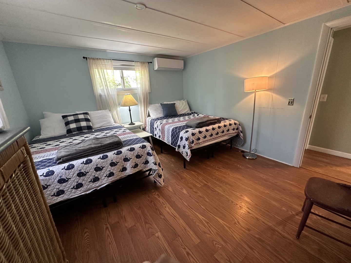 Rest peacefully in your cozy twin bedroom with soft quilts, warm lighting, and air conditioning for perfect comfort.