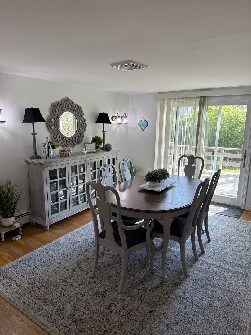 Step into a bright, thoughtfully designed dining space where you'll share meals around a stylish table with elegant seating and charming décor touches that feel like home.